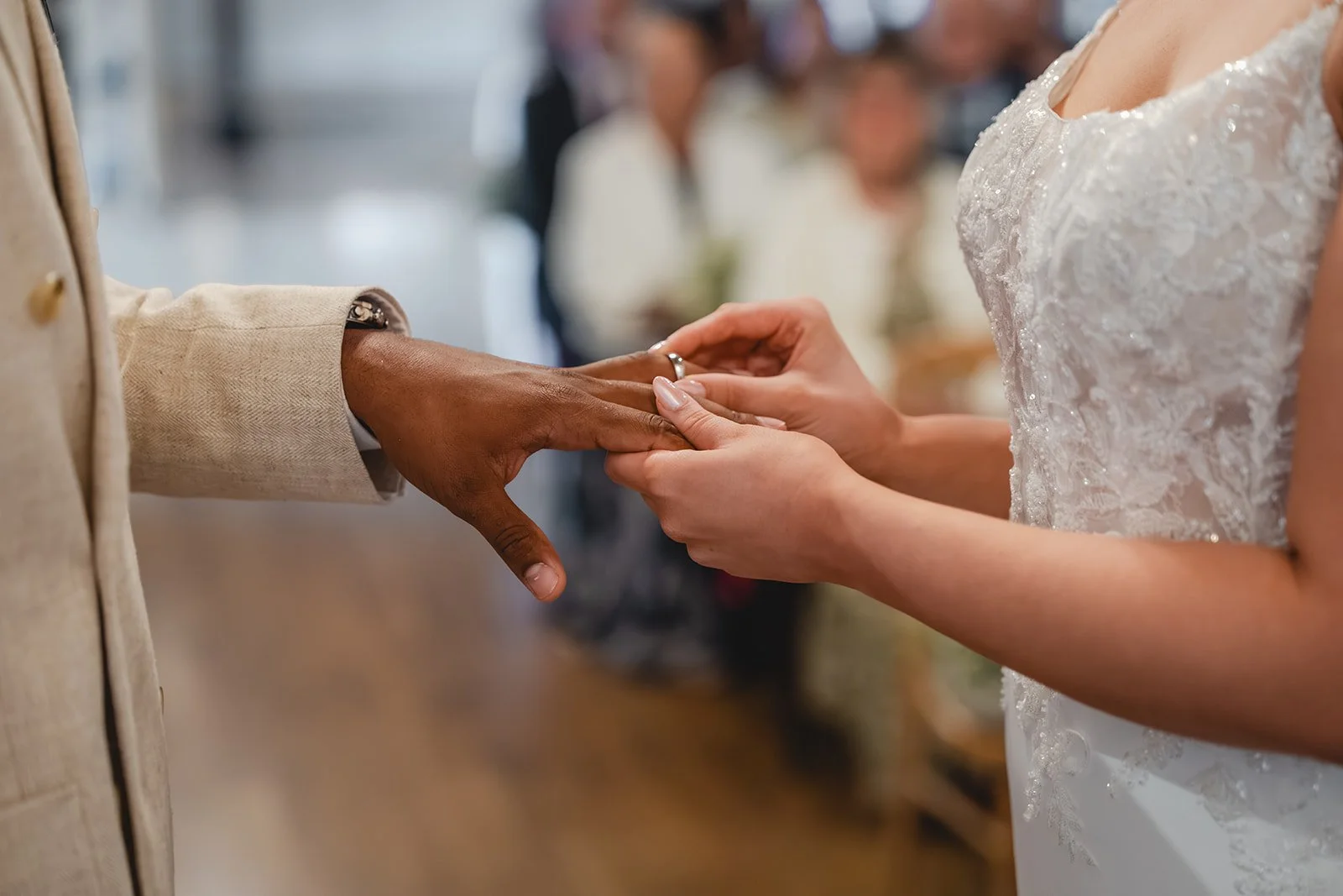 Kirsten placing Josh's wedding ring on his finger