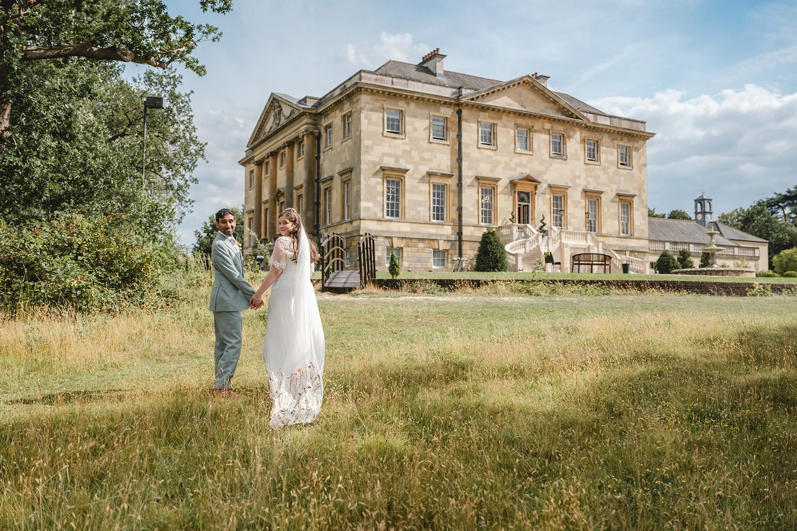 Dorothea and Peter looking back towards camera outside wedding venue