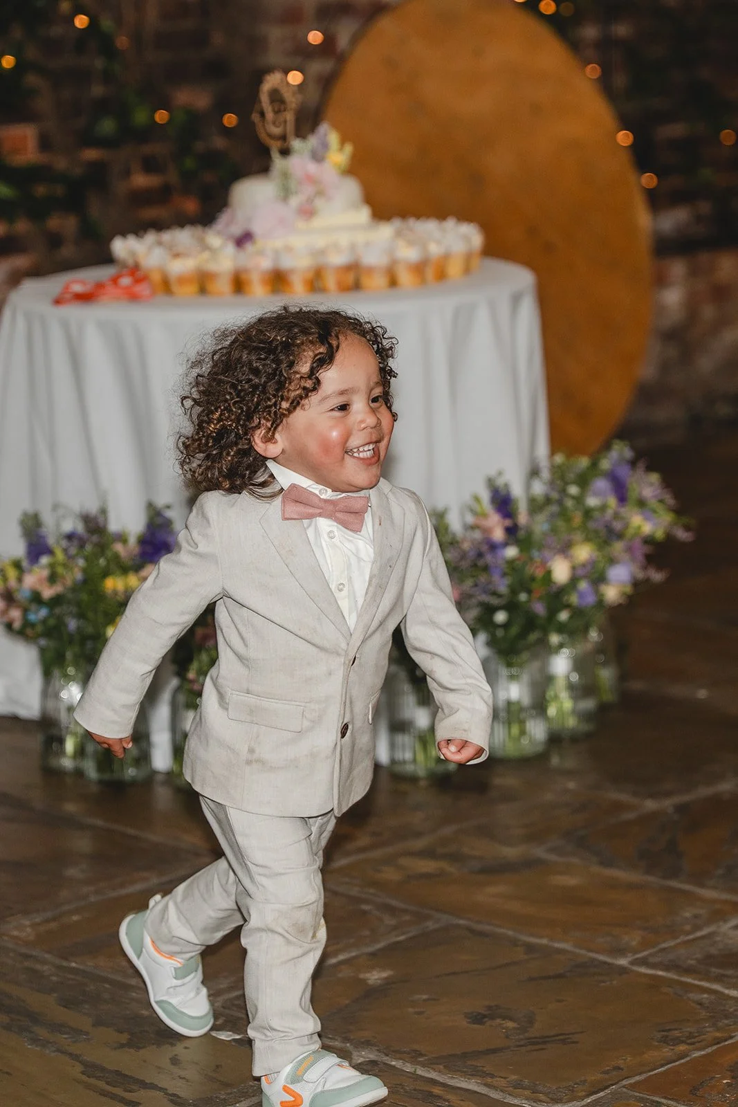 Young wedding guest running during Jonny and Abi reception