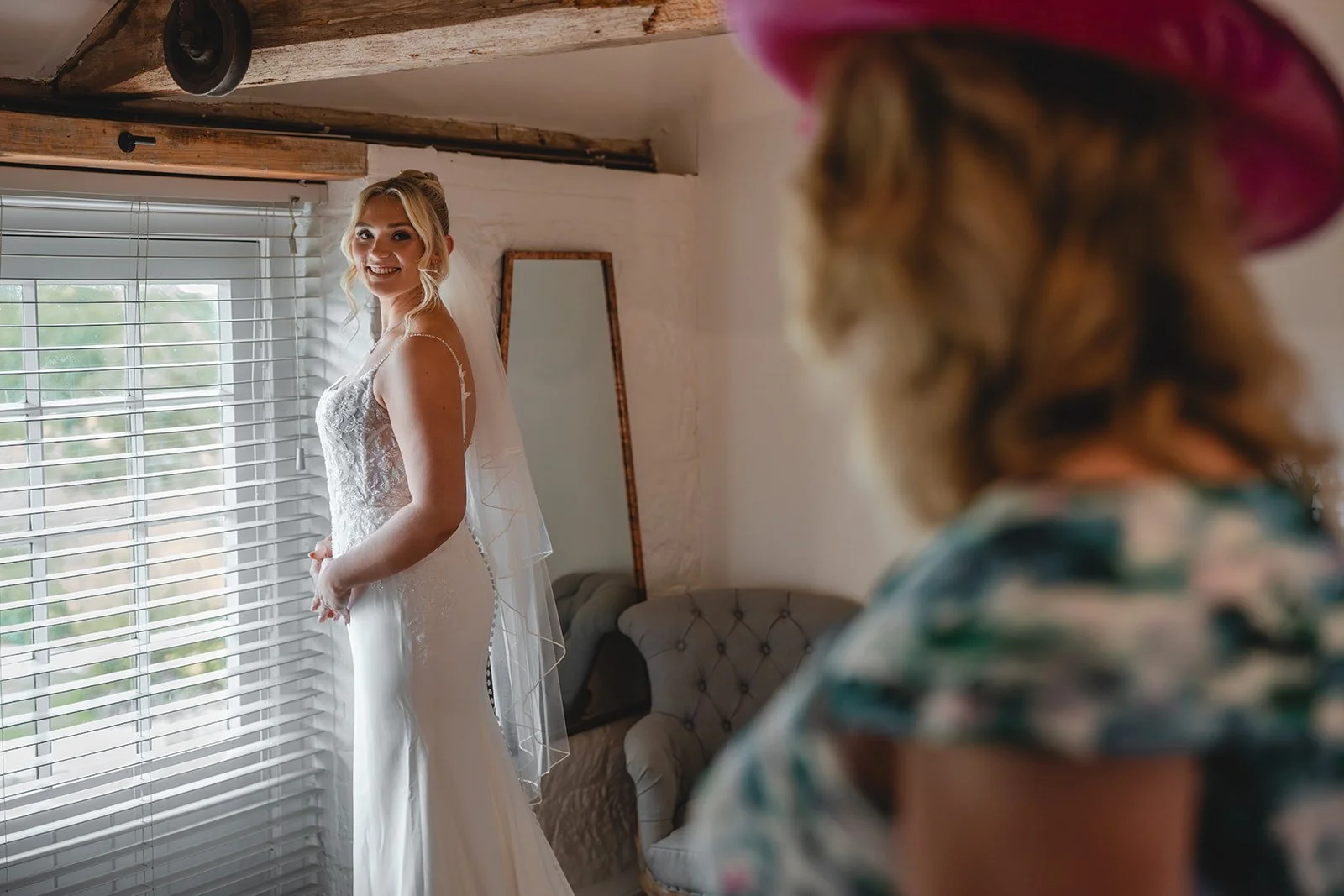 Kirsten smiling in her wedding dress before the ceremony