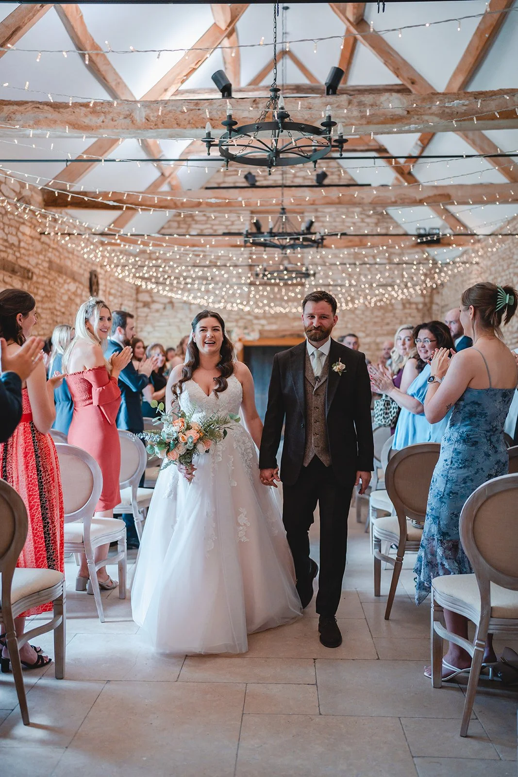 Sartis and Callum walking back down the aisle