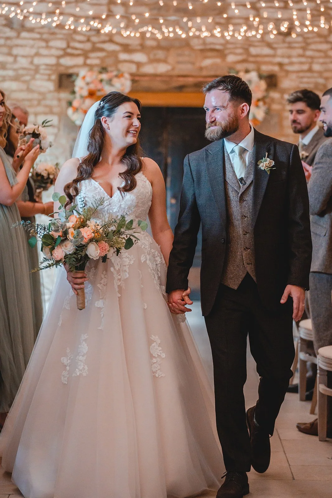 Sartis and Callum walking down the aisle after the ceremony