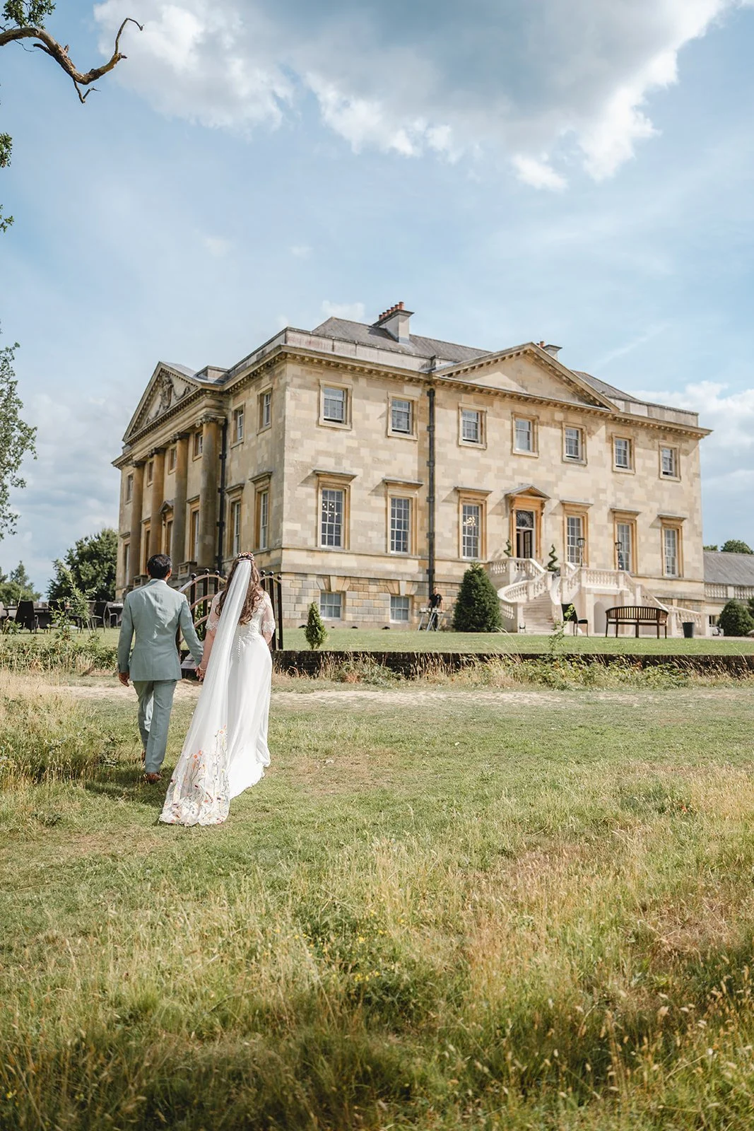 Dorothea and Peter walking through wedding venue grounds
