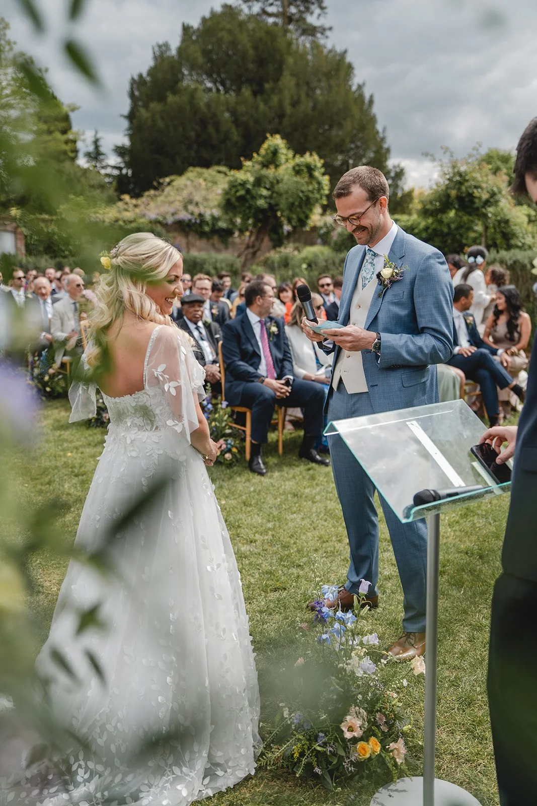 Jonny reading vows to Abi during the garden ceremony
