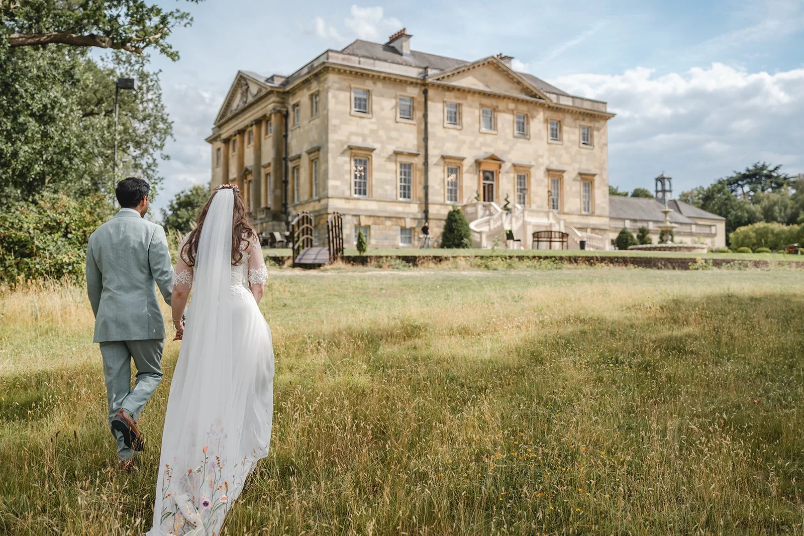 Dorothea and Peter walking through the grounds of their wedding venue