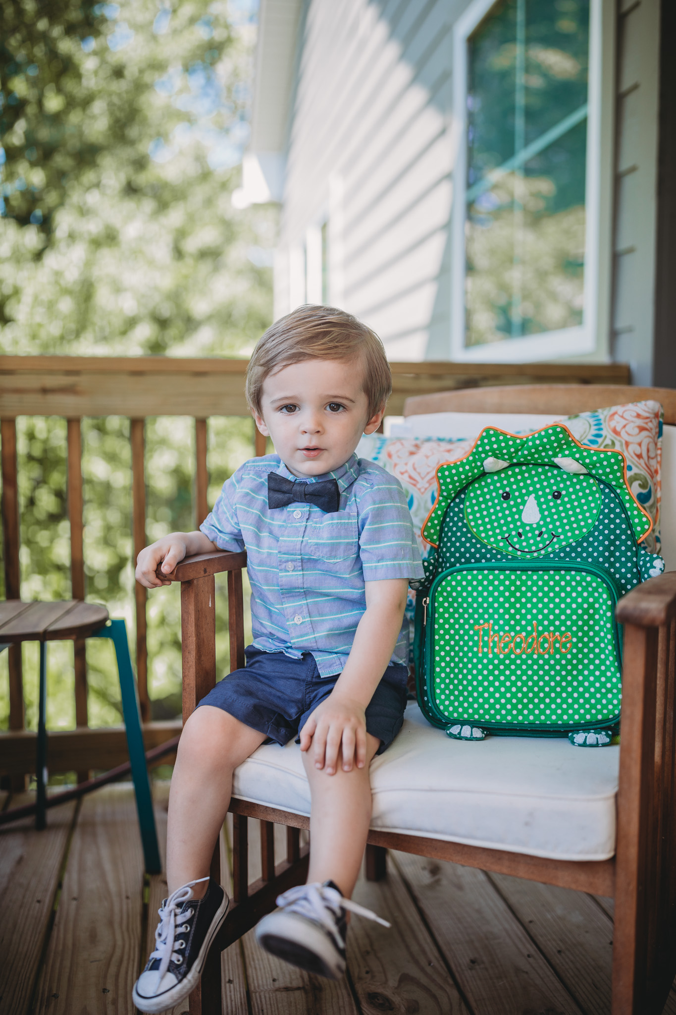 toddler sitting with backpack