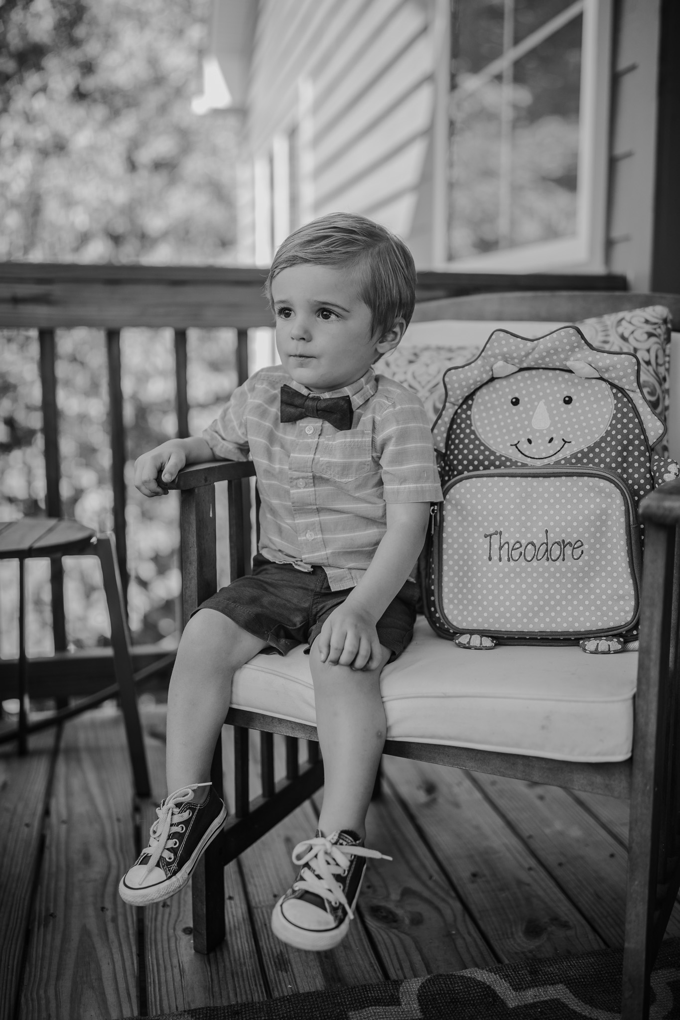 little boy sitting with backpack