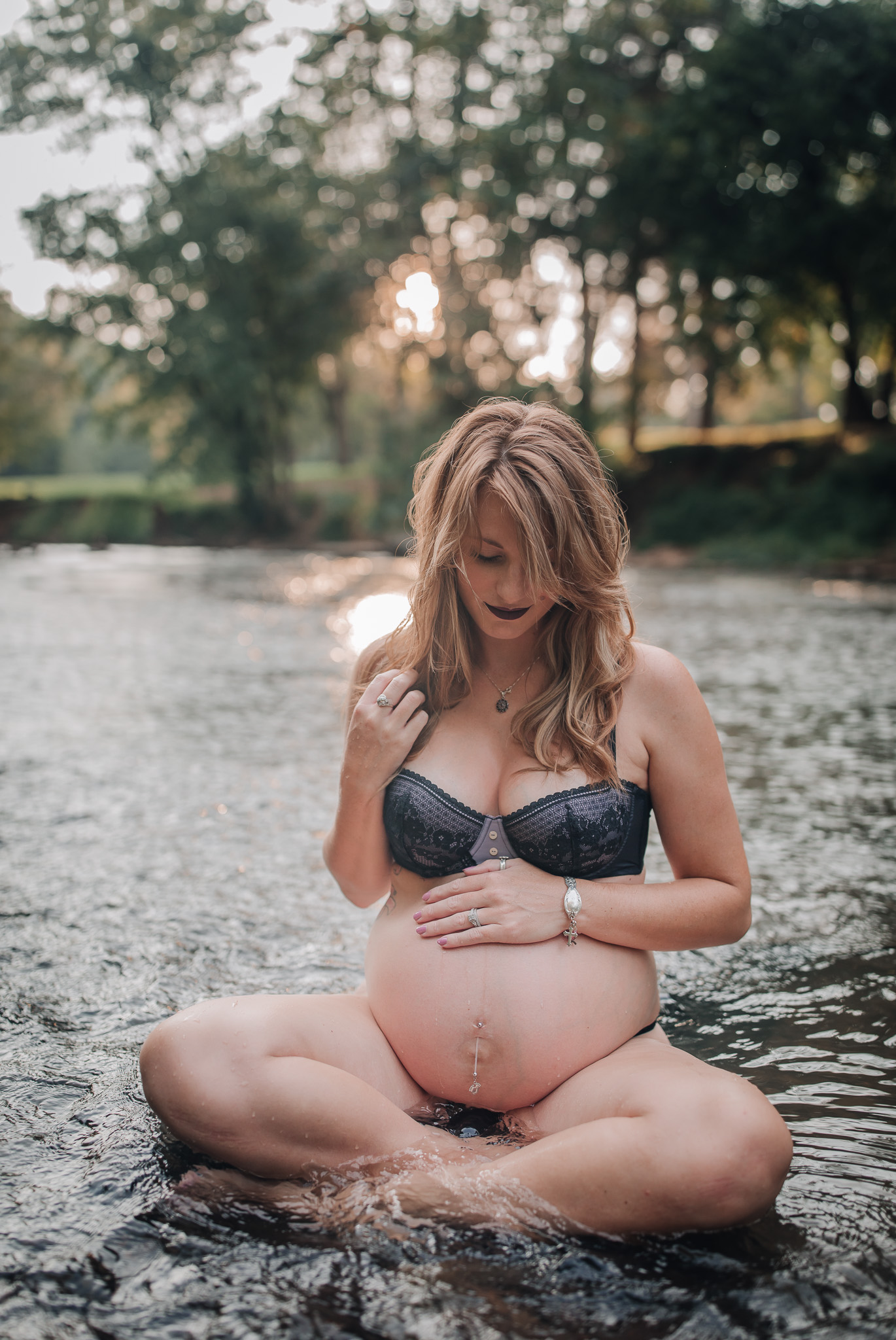 pregnant woman sitting in water outdoor boudoir