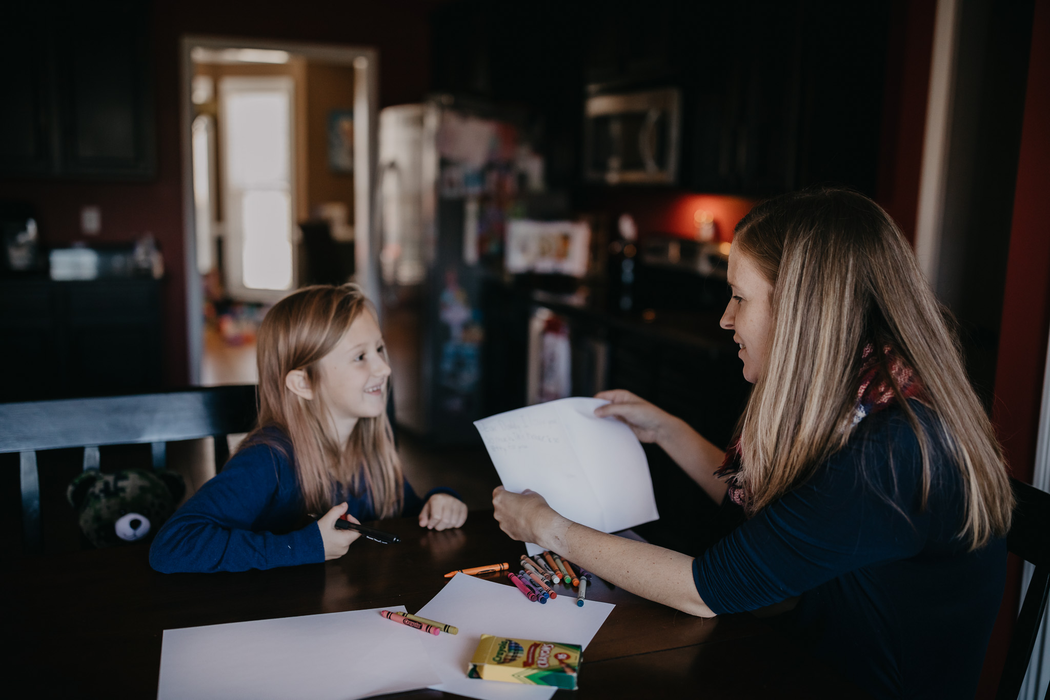 mom and daughter writing to deployed dad