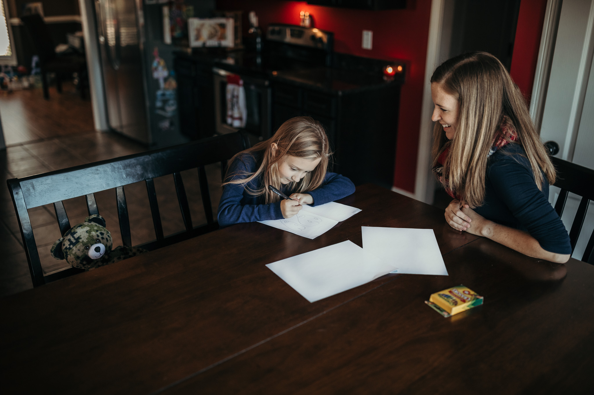 mom and daughter sending deployed dad care package