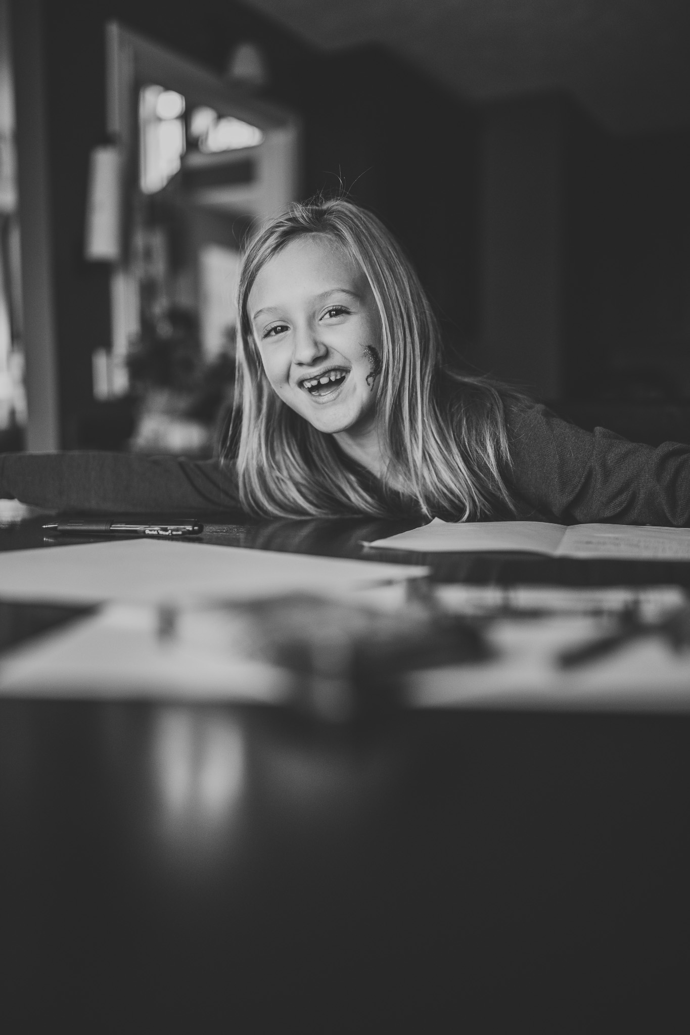 black and white of little girl writing deployed dad a letter