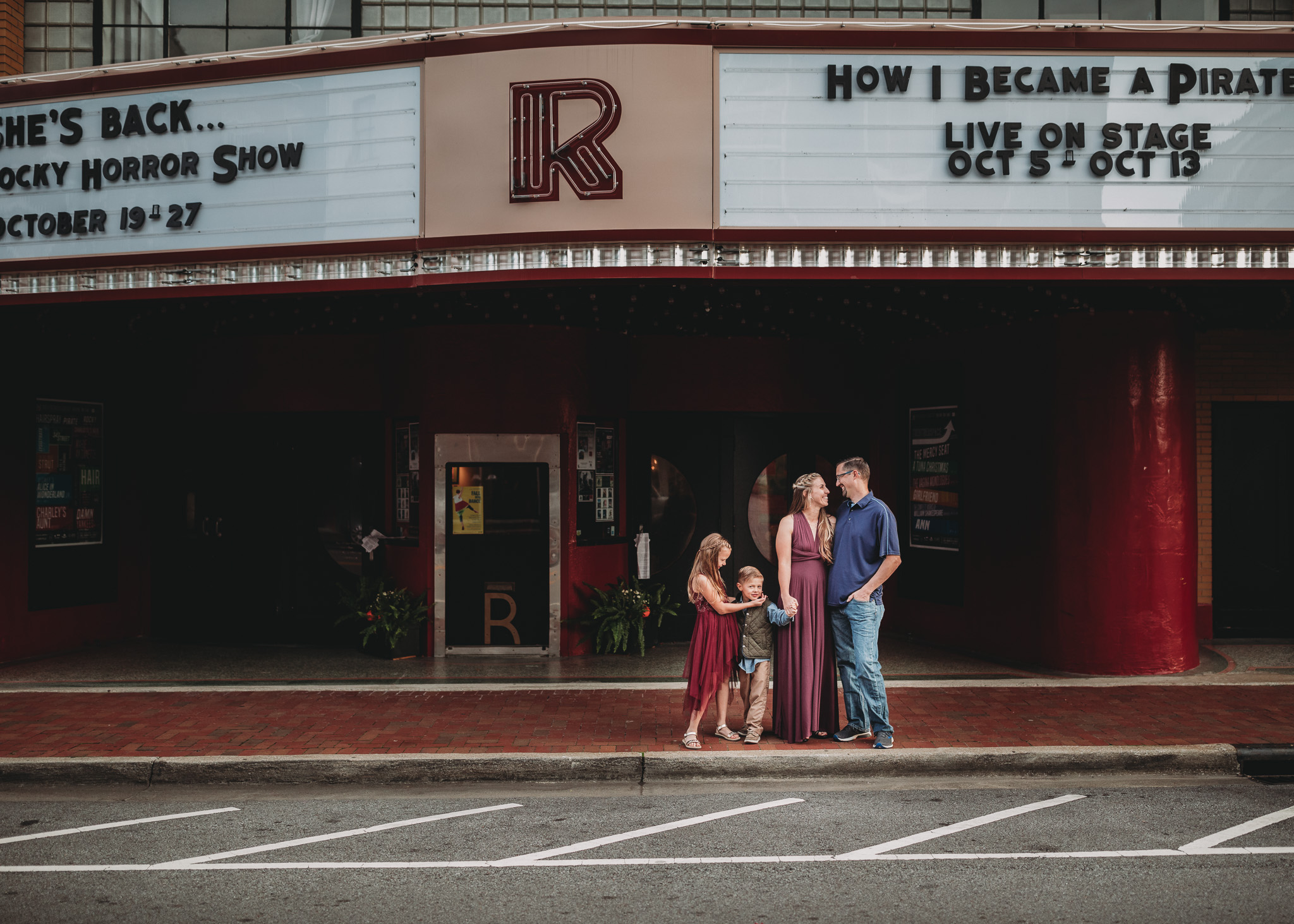 family in front of Roxy theater