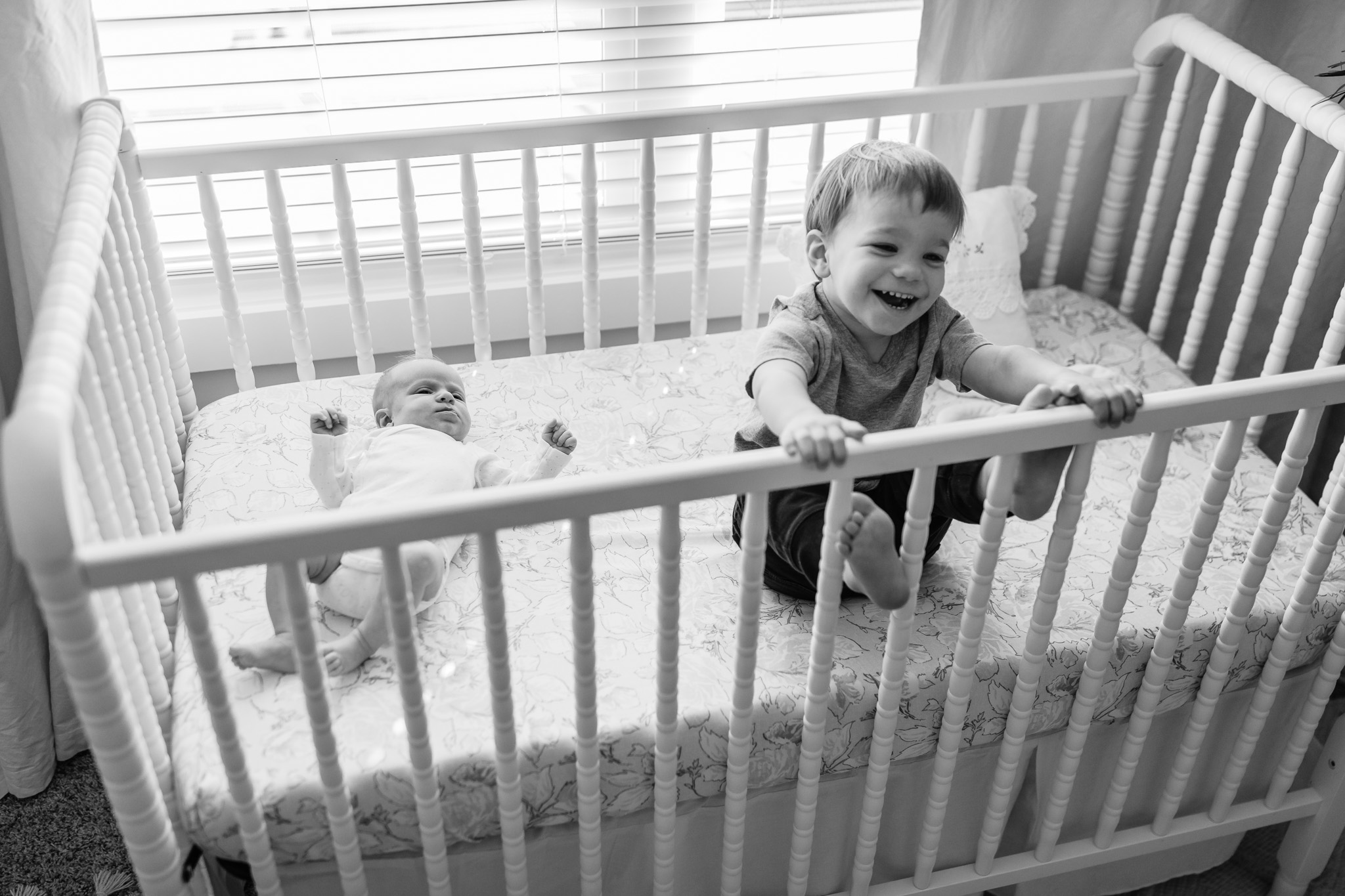 Black and White Siblings in Crib