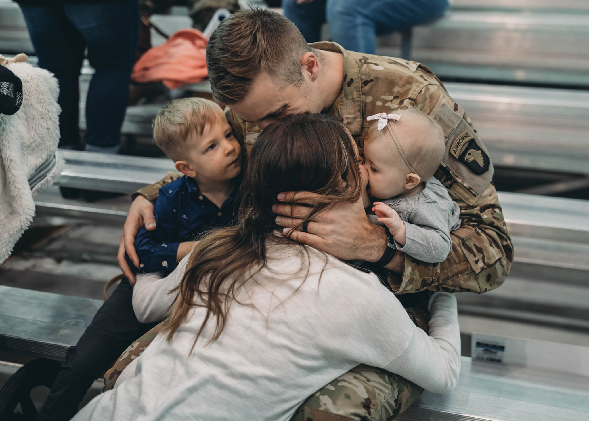 Military Family Sitting and Embracing