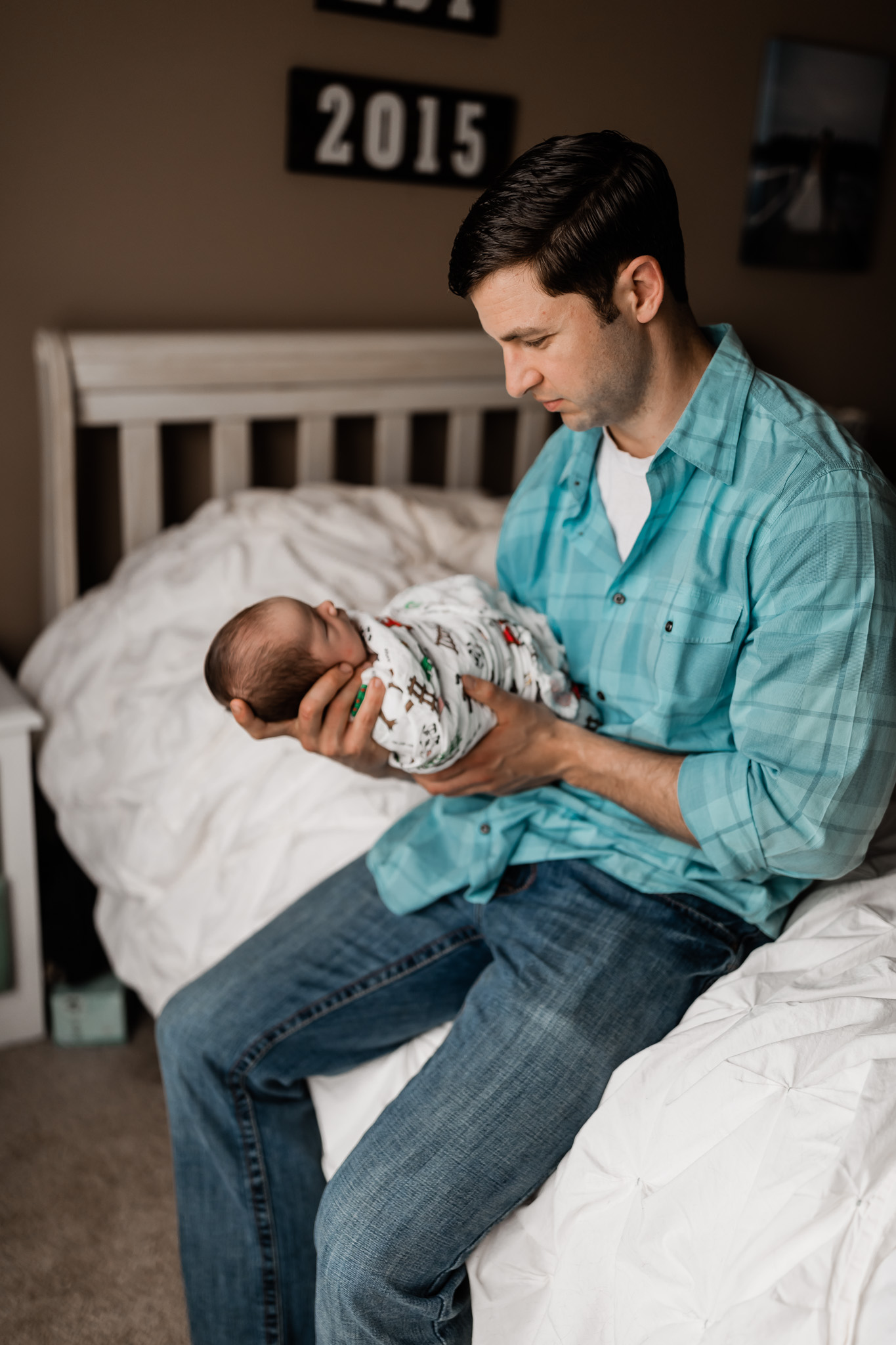 dad looking at newborn