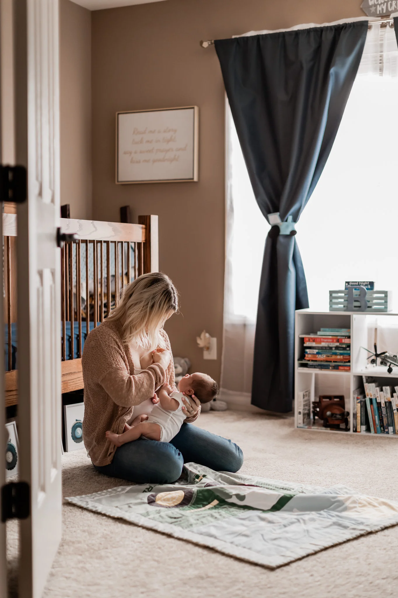 mom breastfeeding baby in nursery