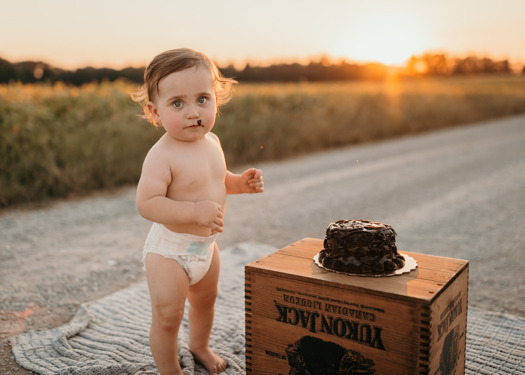 boy smash cake outdoors