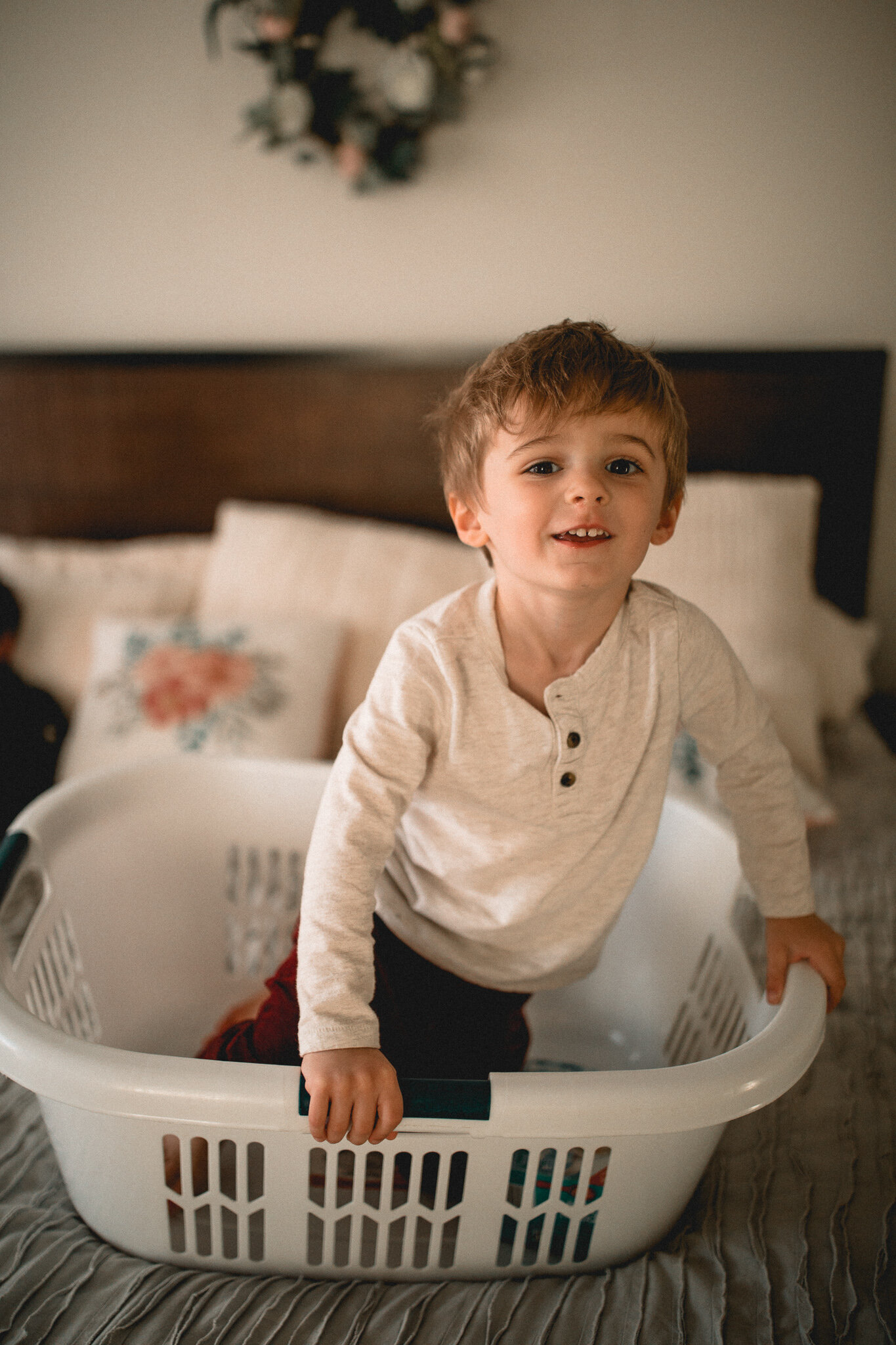 toddler in laundry basket