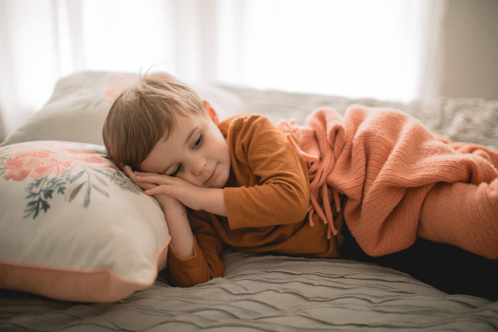 toddler sleeping on bed