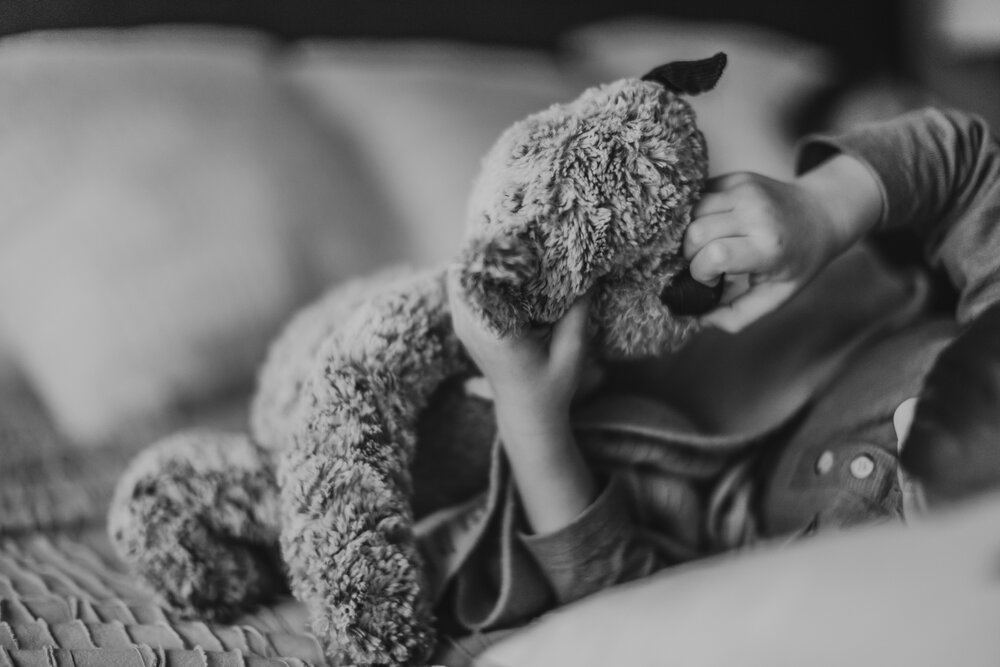 toddler holding the giving bear