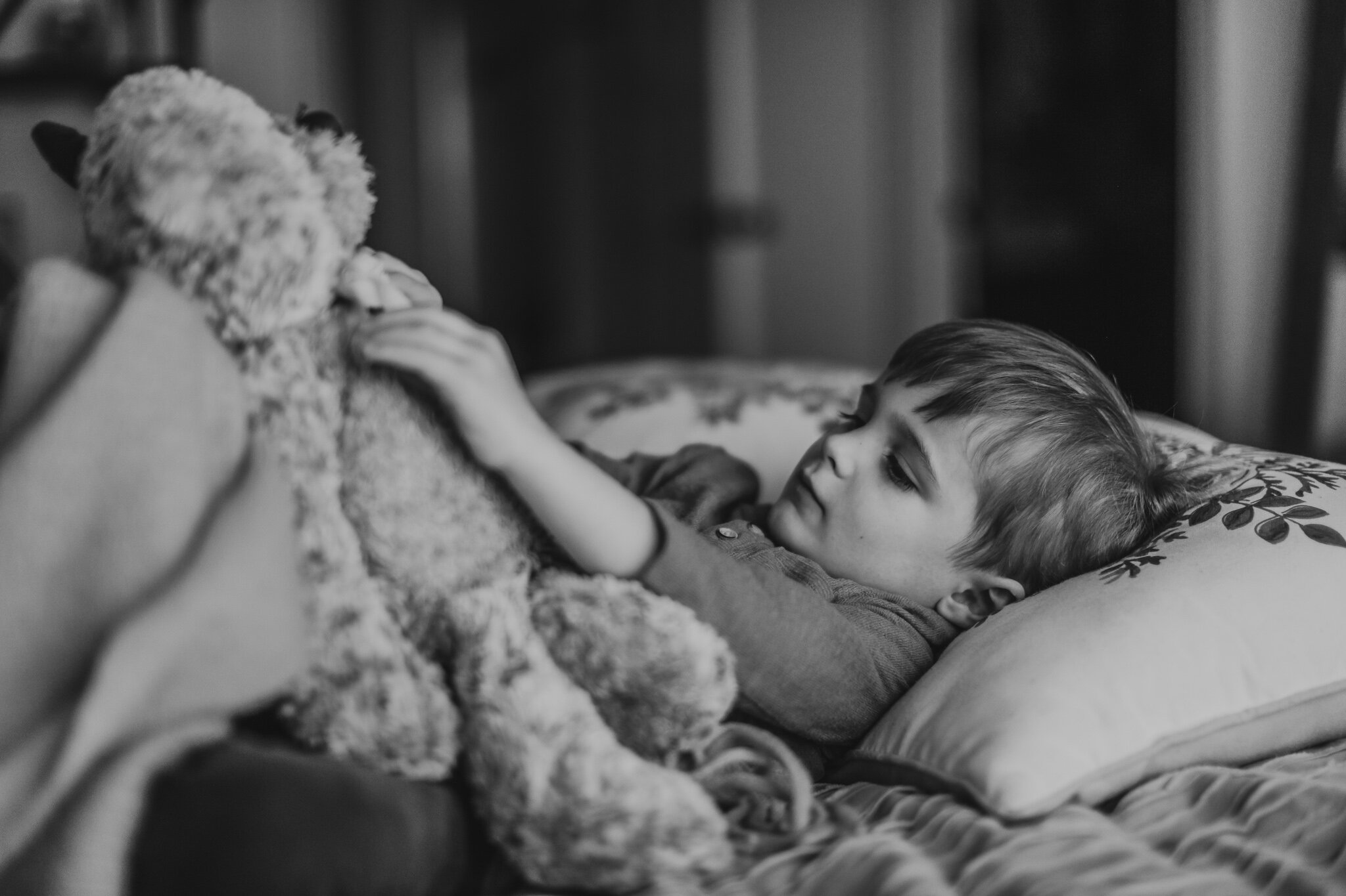 toddler snuggling with giving bear