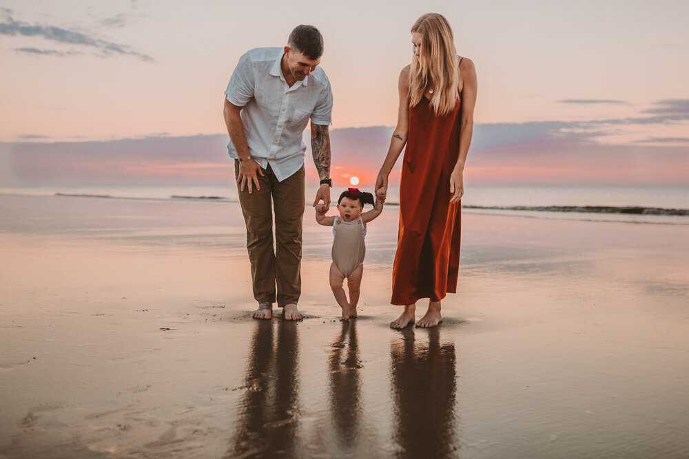 family on beach for sunrise 