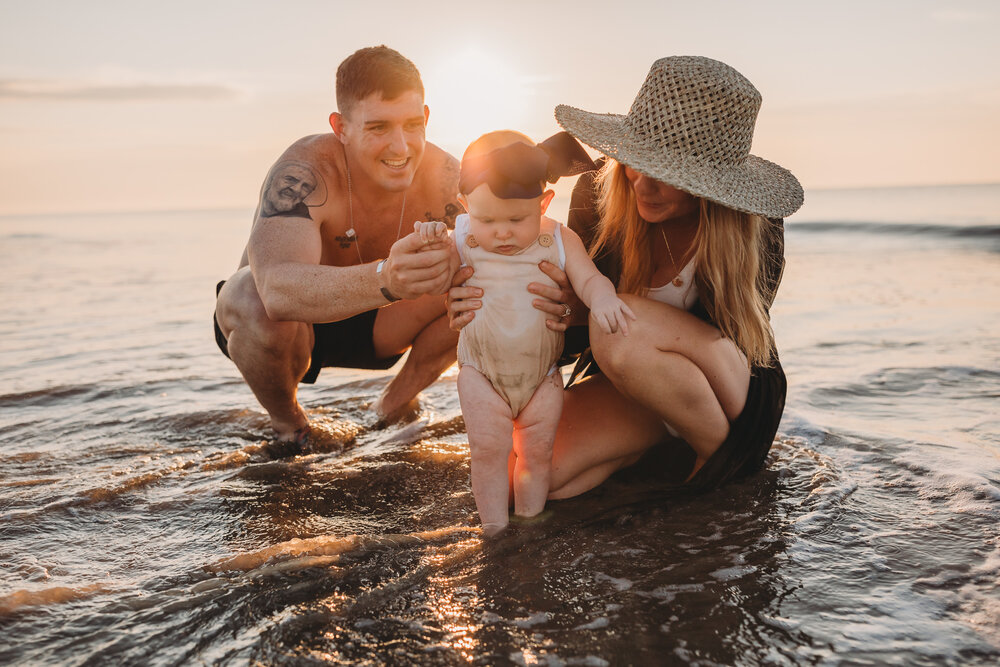 family on the beach at sunrise on jekyll island