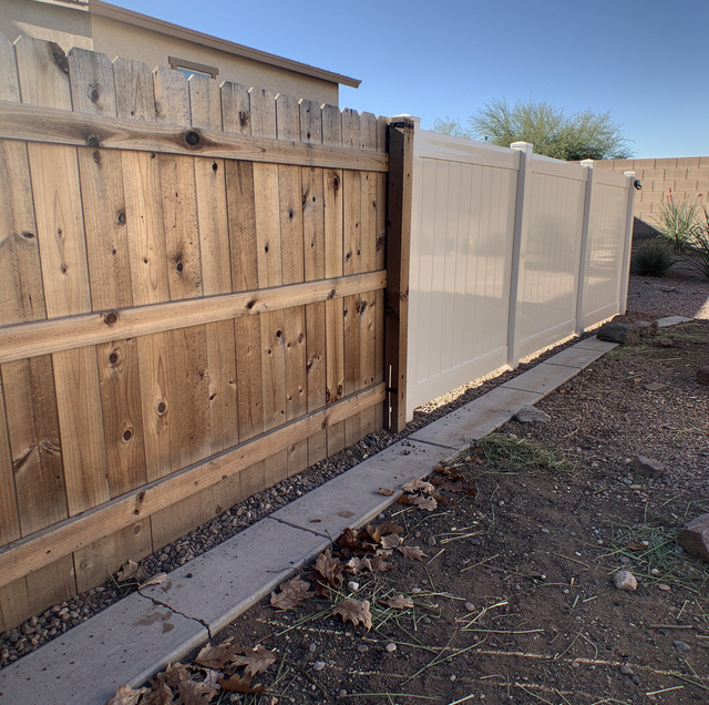 sun-bleached wood fence with peeling stain beside intact vinyl panel