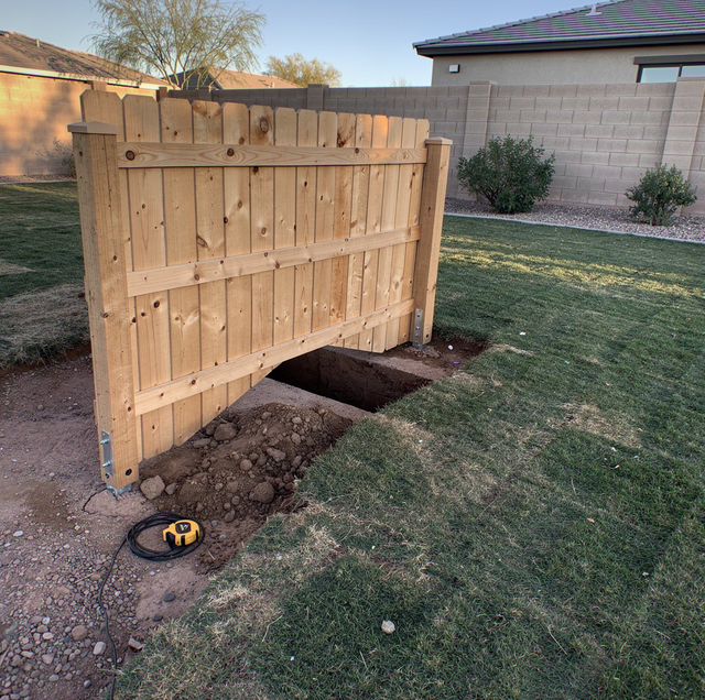 Sloped backyard fence with stepped posts following downhill grade