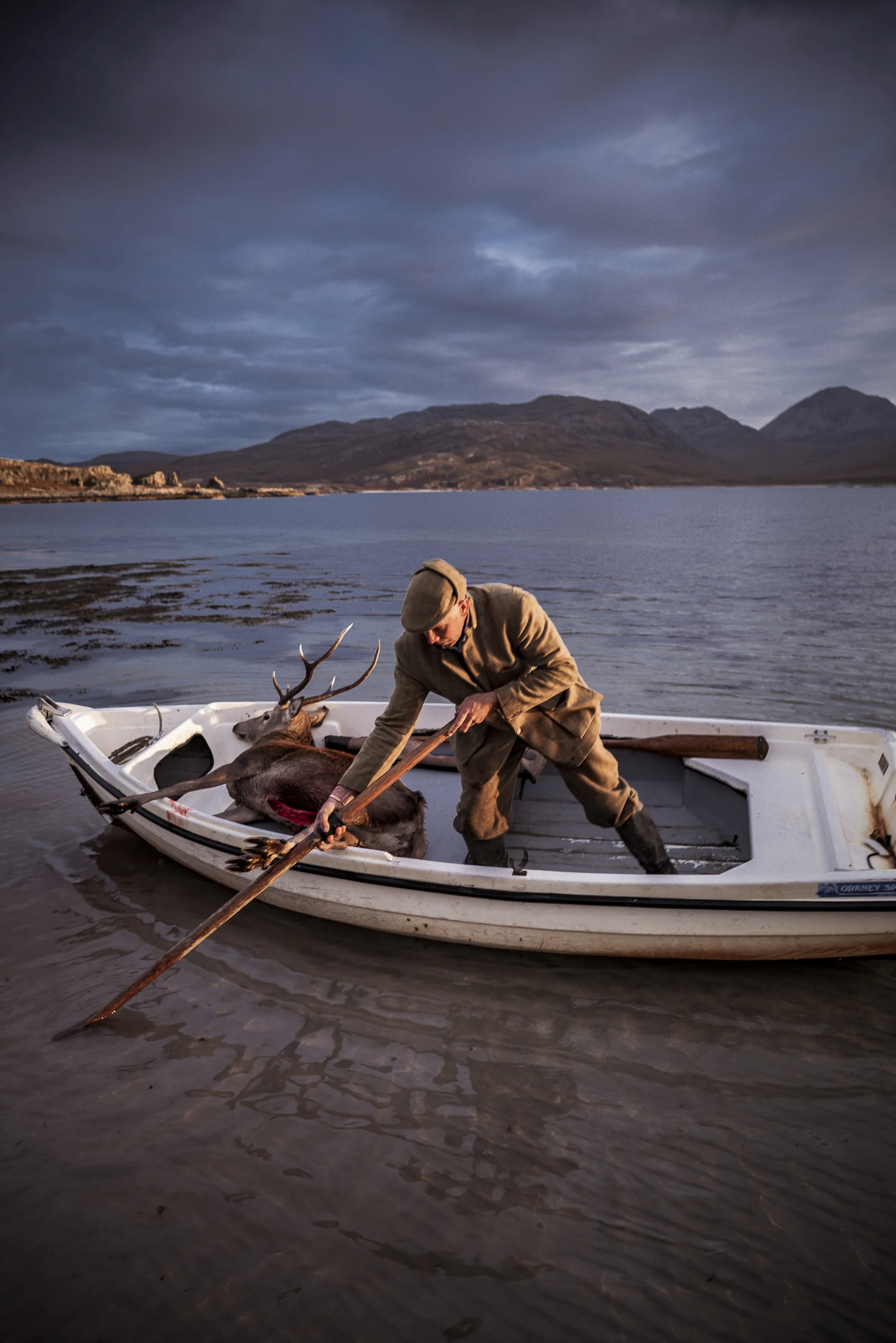 Deer Stalker in boat heading home 