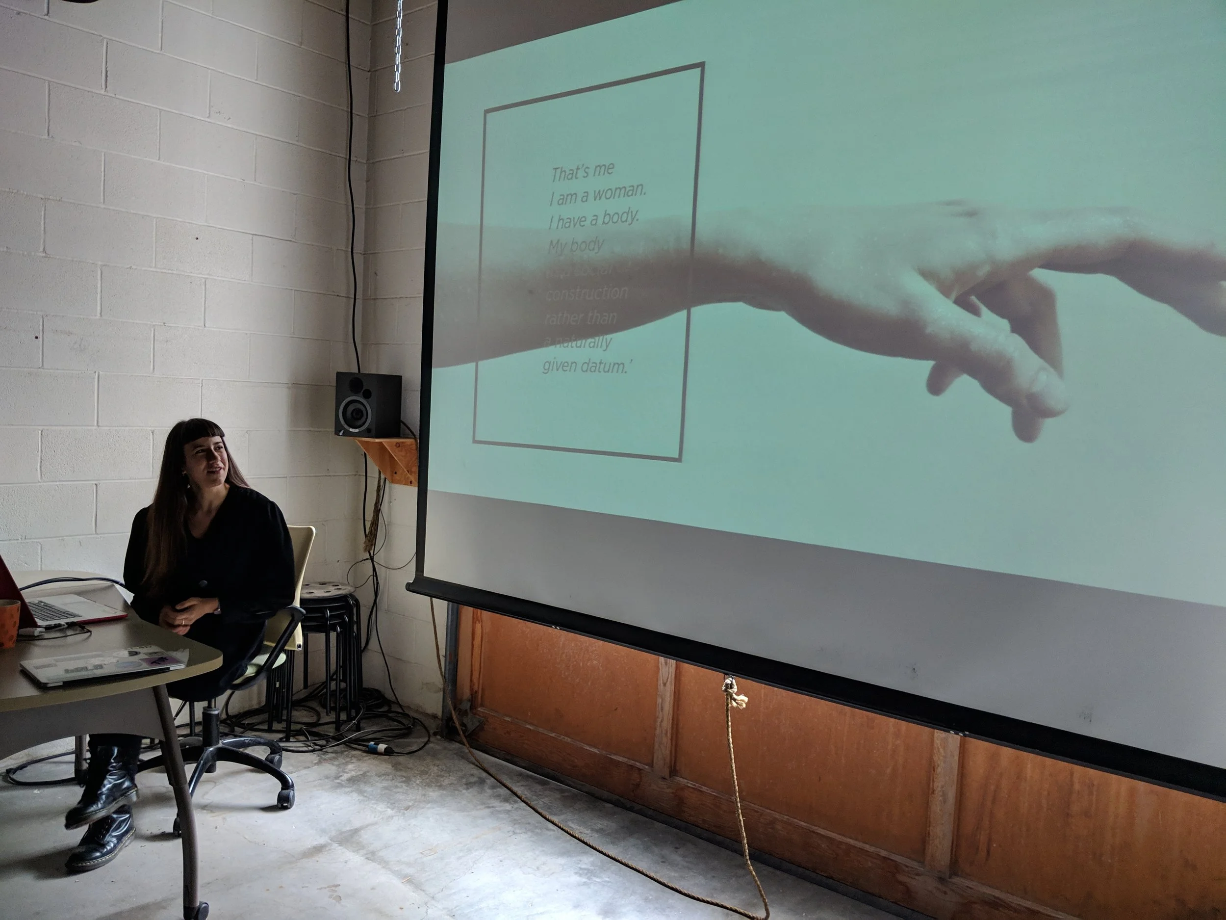 Giulia Tomasello introducing her work to the DXARTS 490 students with this quote from Simone de Beauvoir: “That’s me. I am a woman. My body is a social construction rather than a naturally given datum”.