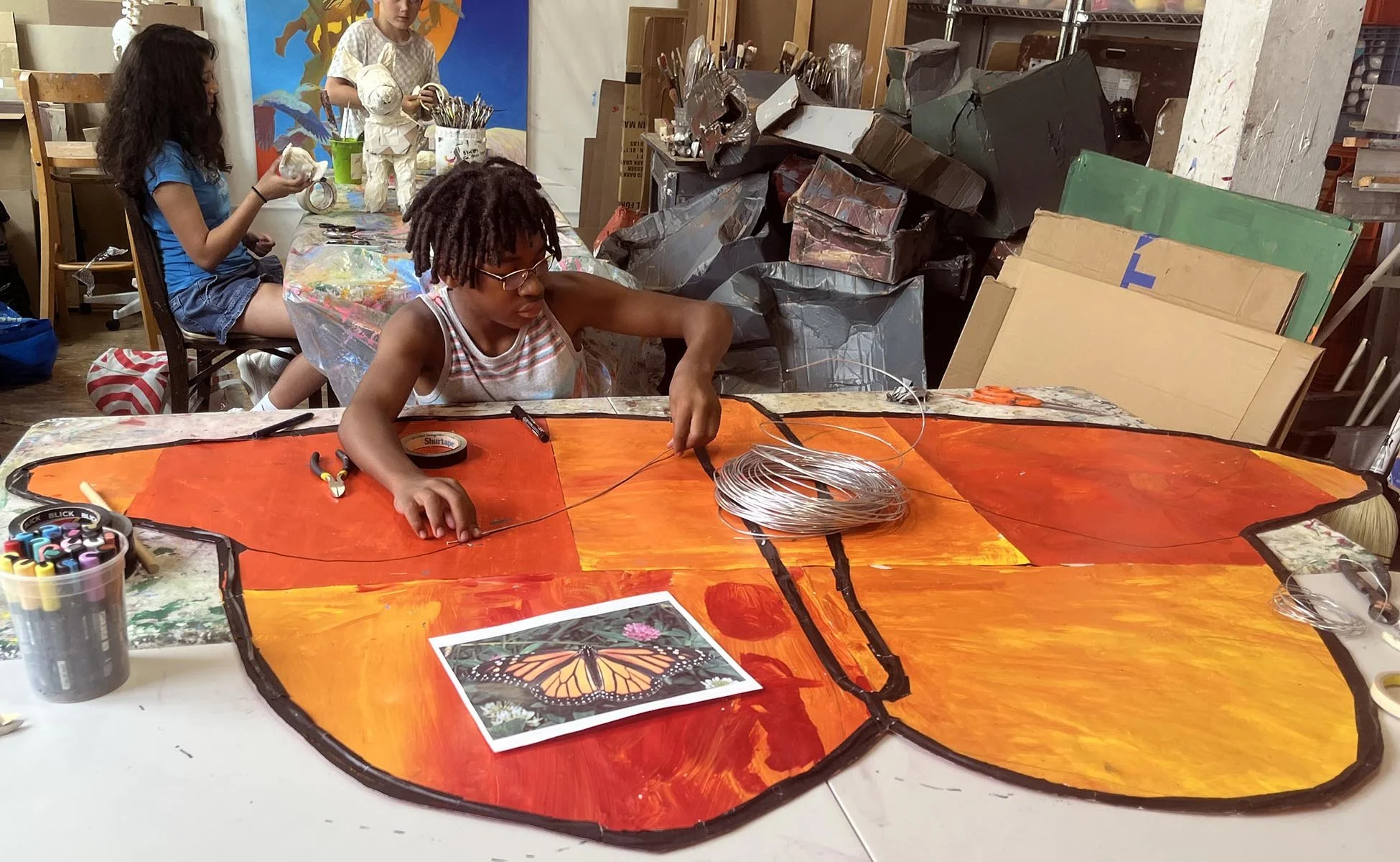  After learning about monarch butterfly migration, Jelani figured out how to create a huge butterly and hide the wire structure it needed to support itself. These big artworks became some of the visual themes of the show.  