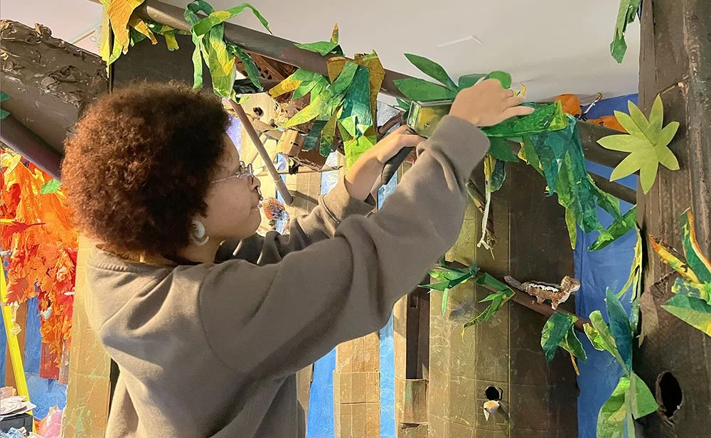   Welcome back to Kenzie, who created the mural for the back wall of last year’s installation, and is now a mural painter with Mural Arts!  