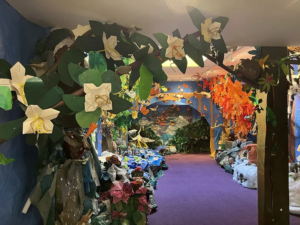   Young artists invented a way to make origami blossoms for our umbrella magnolia tree.  