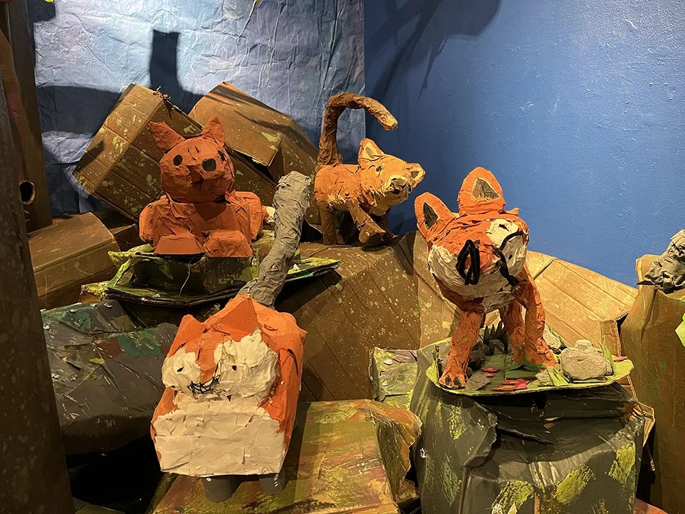   Fox families grow as a new generation of fox kits is born and plays on the rocks.  