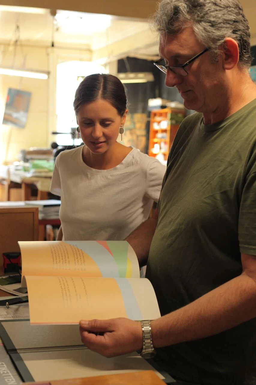 Andrew fits the pages into the cover.