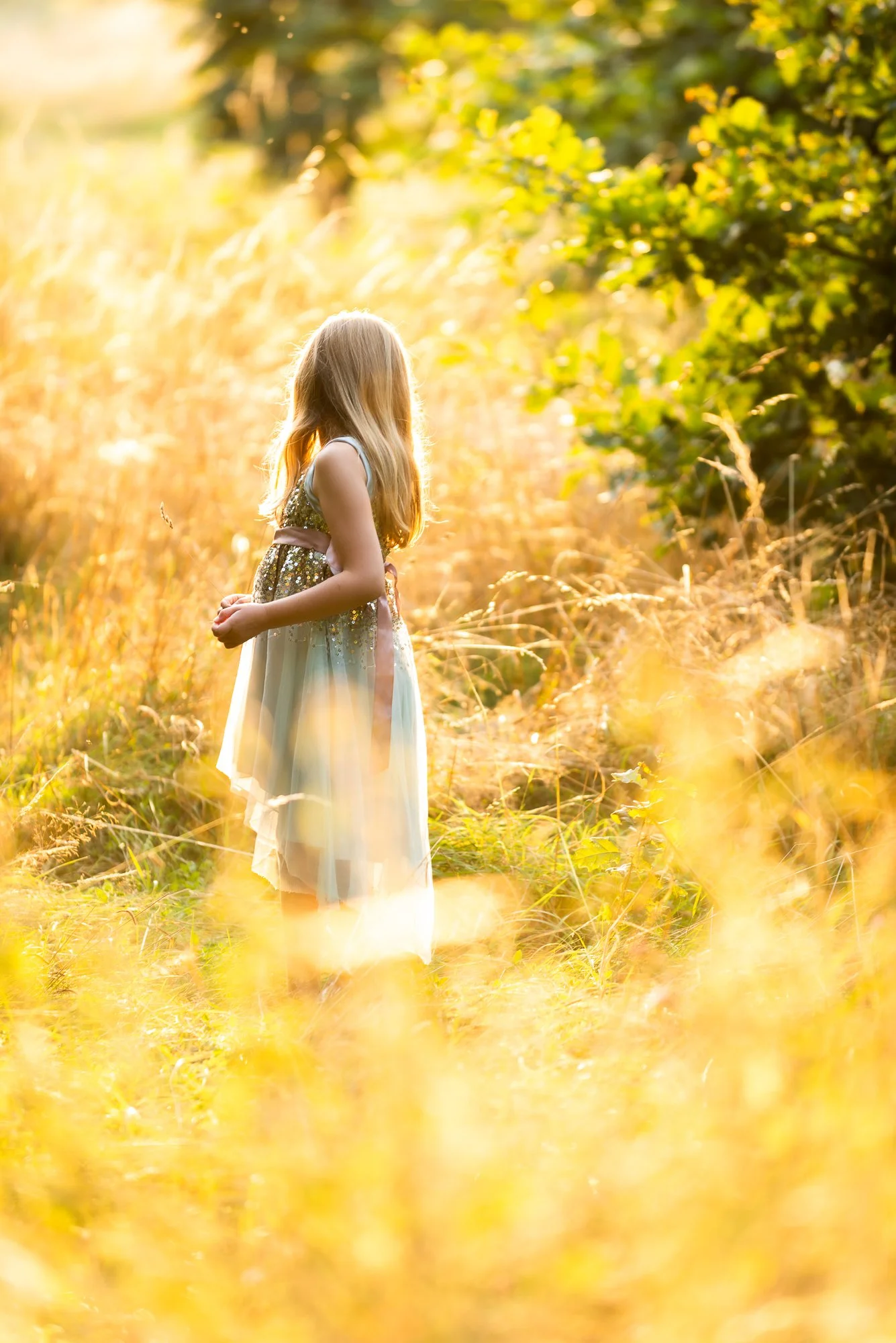 girl in field at sunset