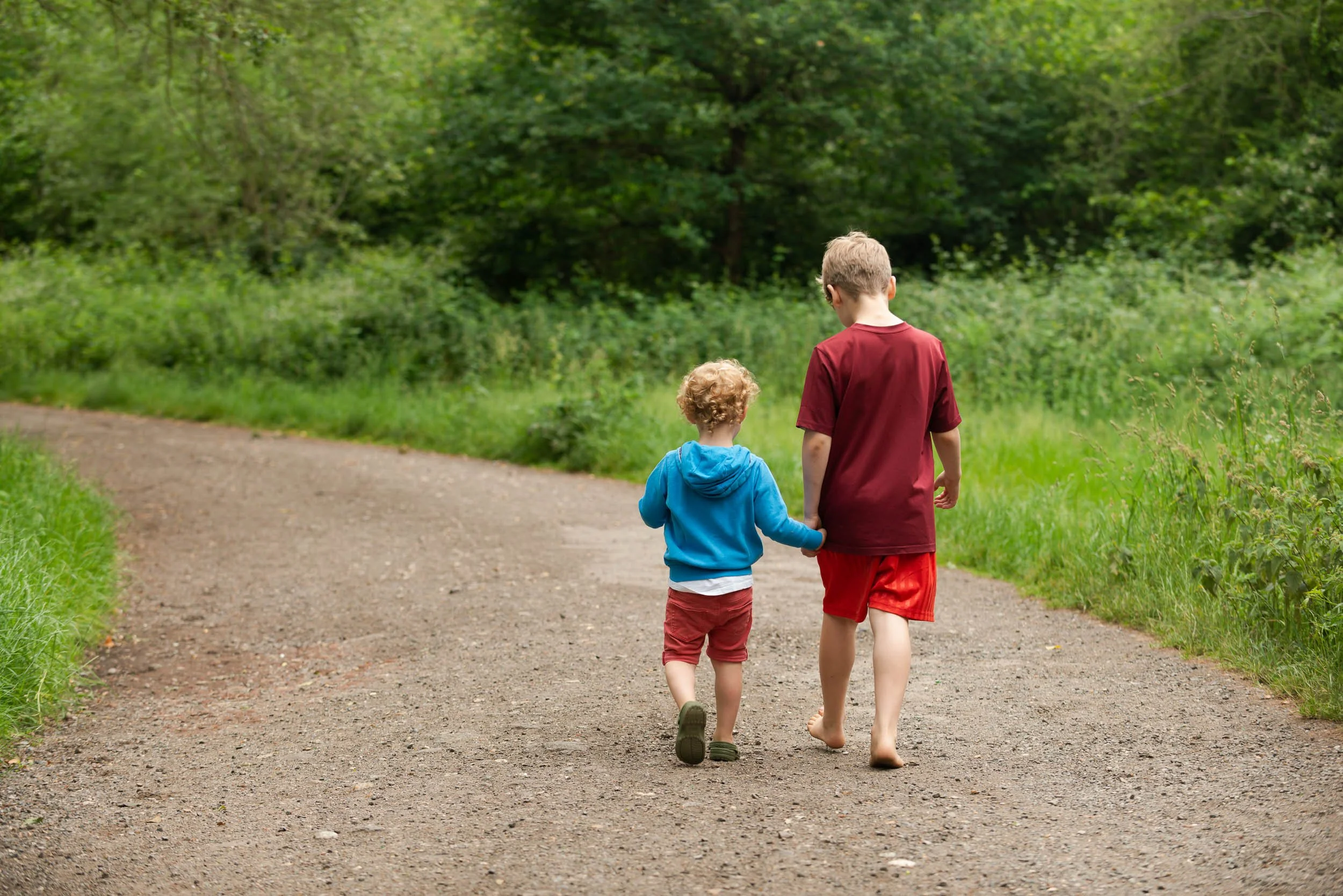 two boys walking along a country lane