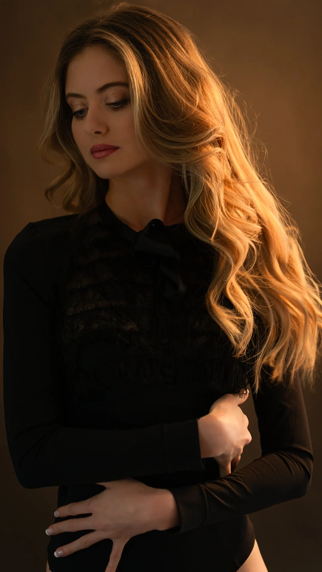 girl modelling in photo studio with golden lighting