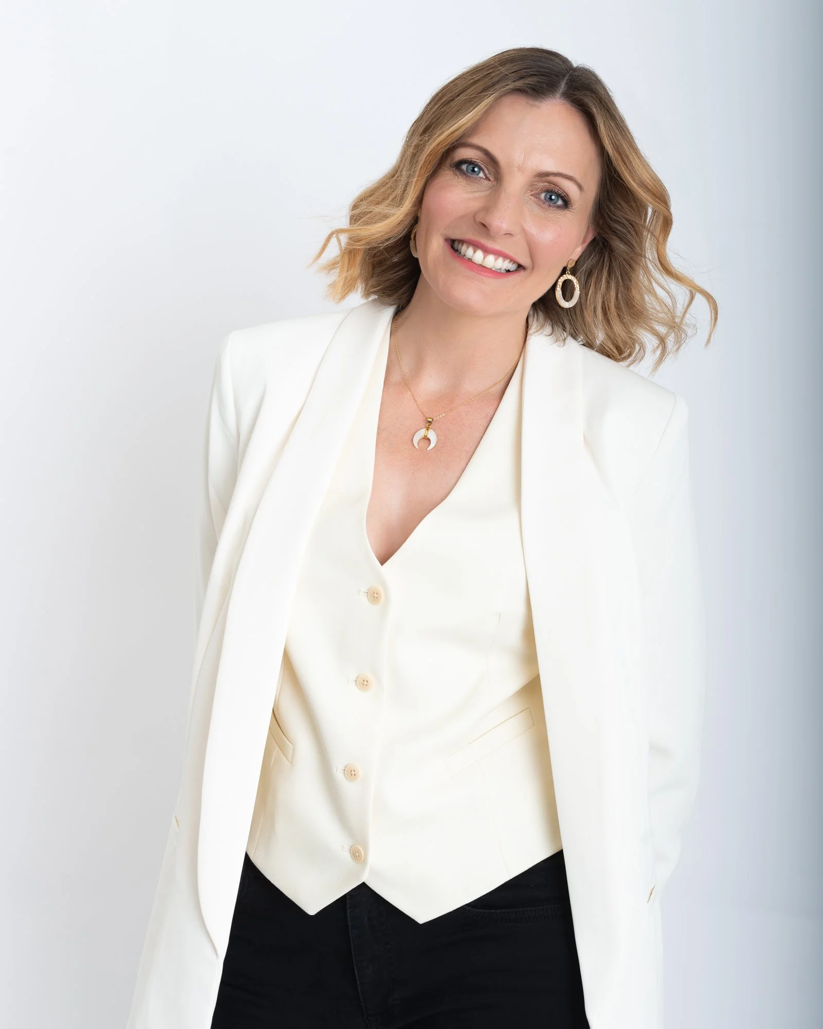 business owner in white suit in a studio