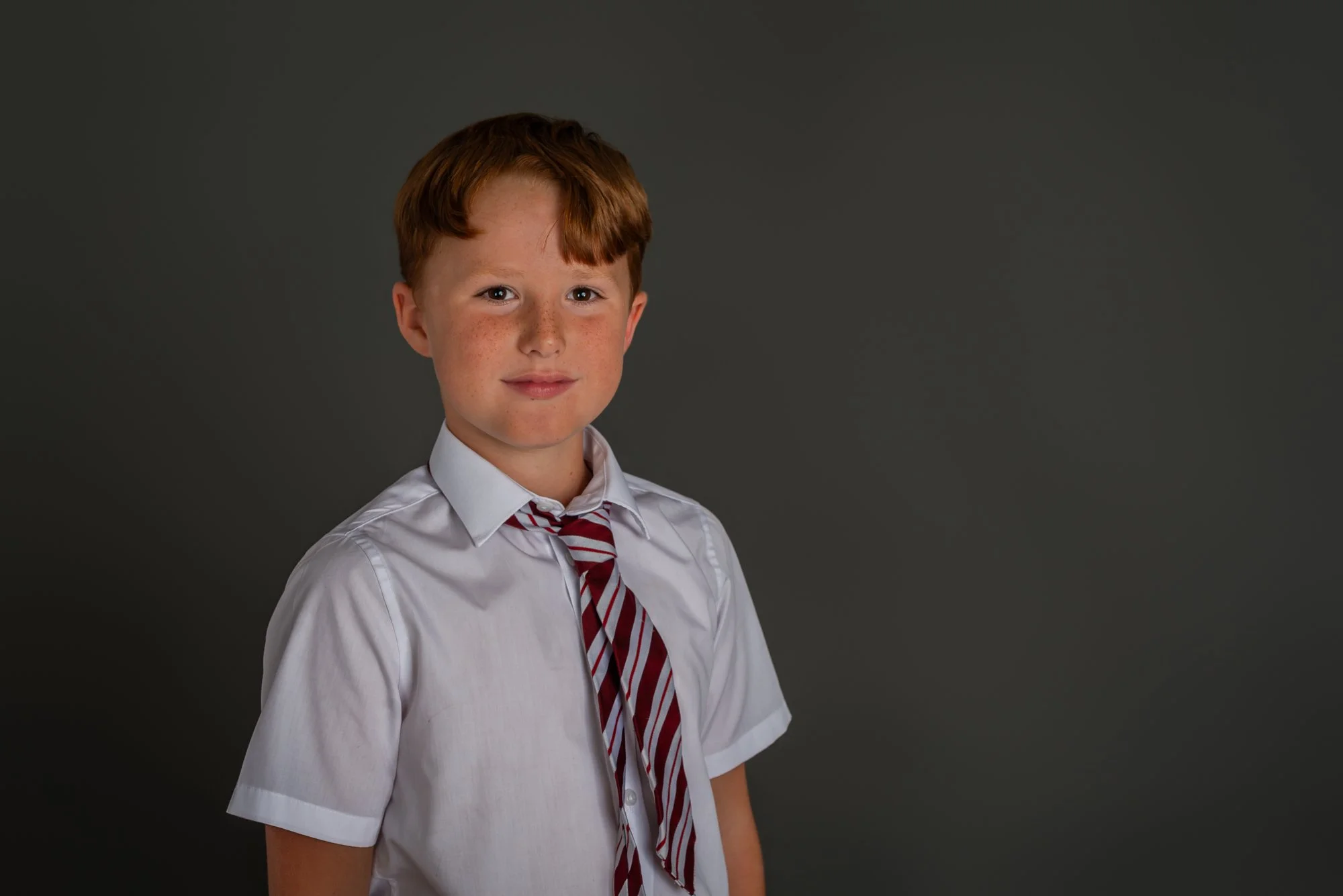 studio photo shoot of boy in new school uniform