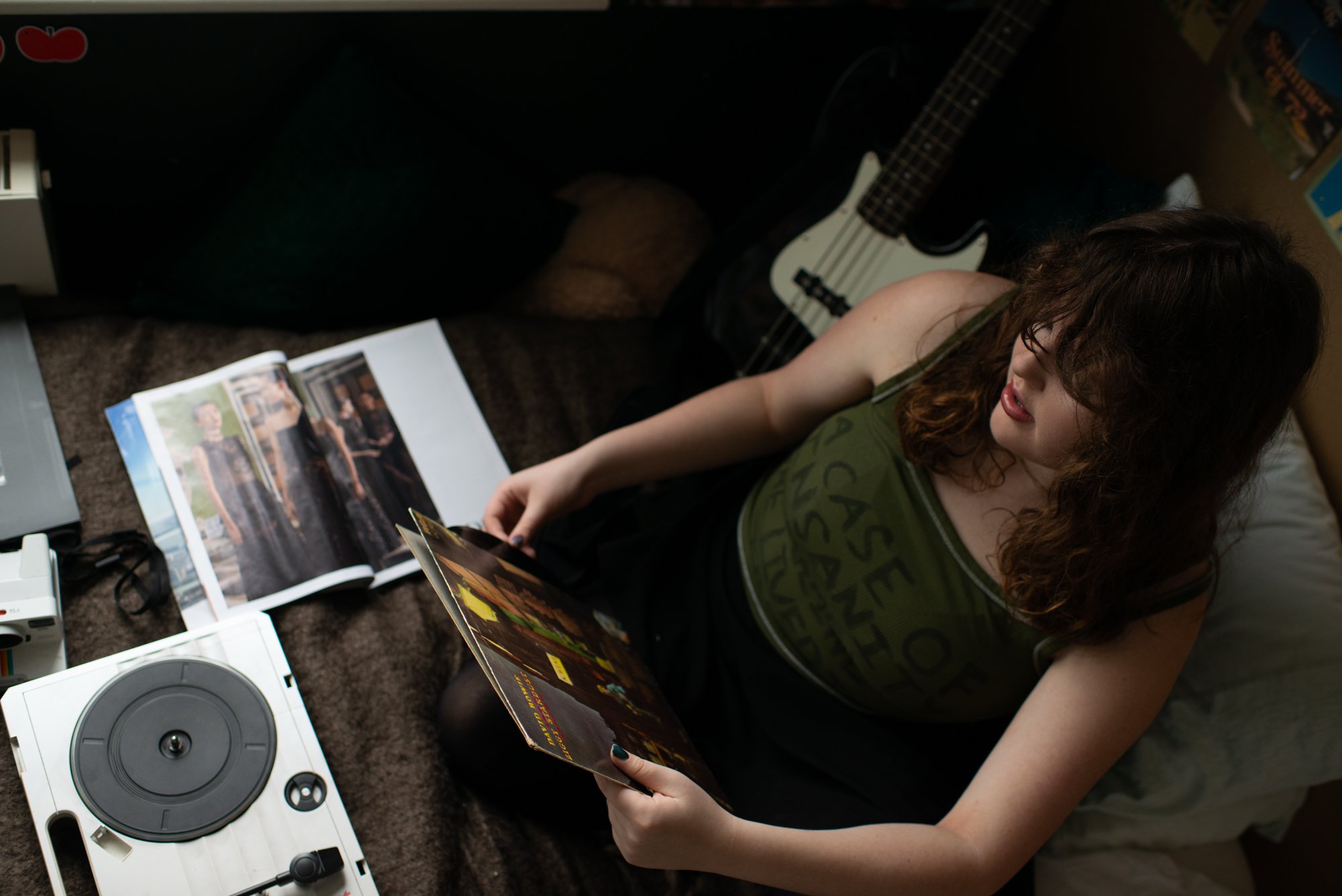 teen in bedroom with records and magazines