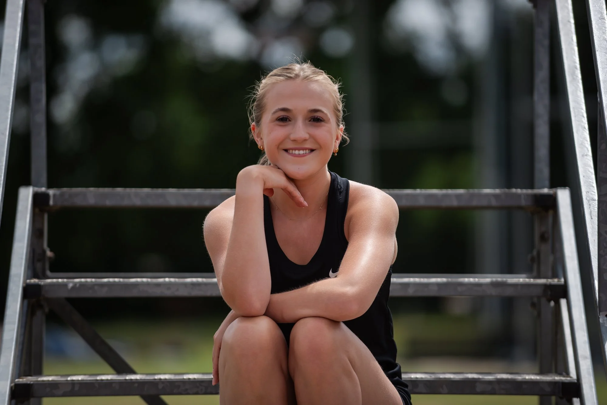 Female runner on steps at running track