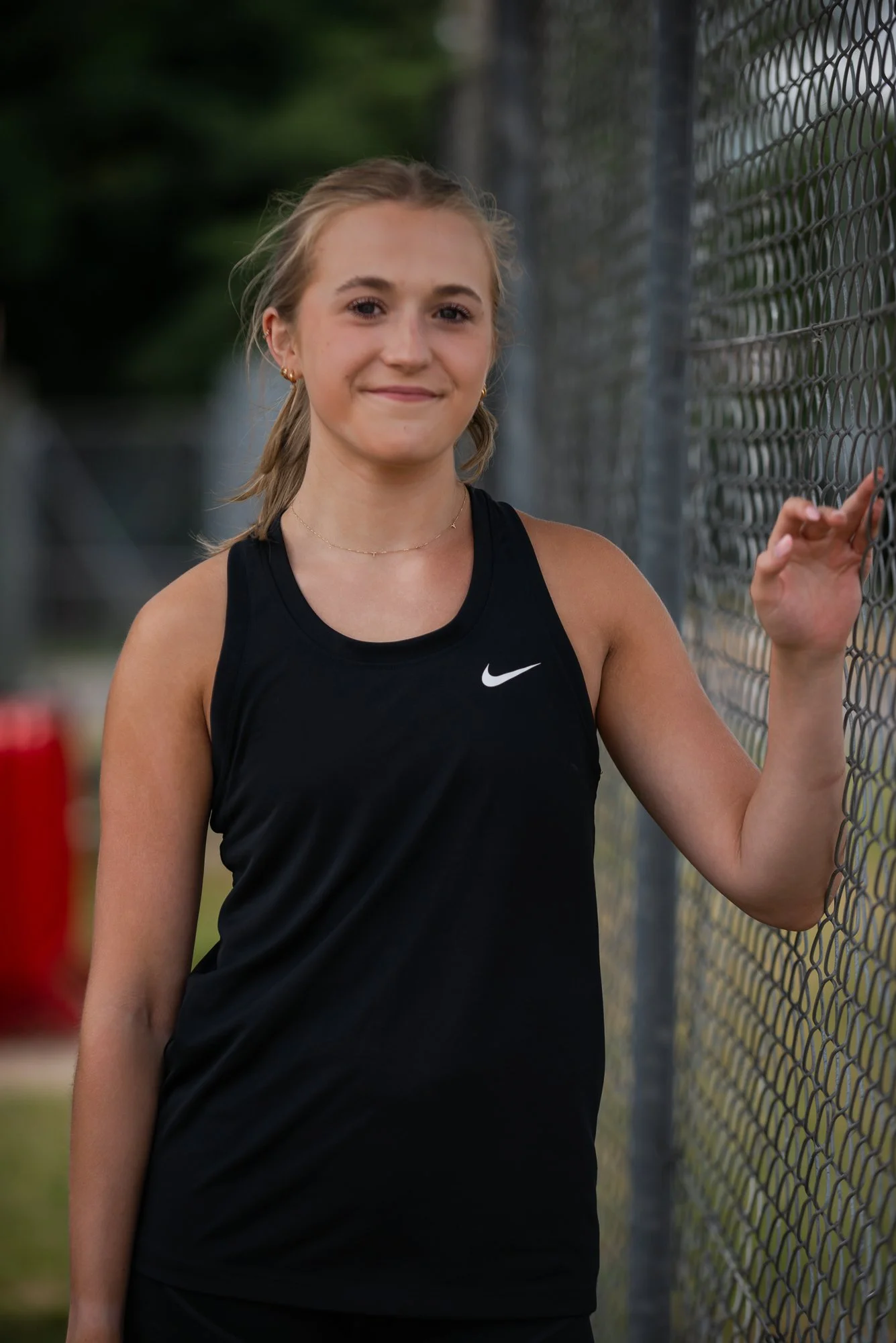 teen girl on running track in nike top
