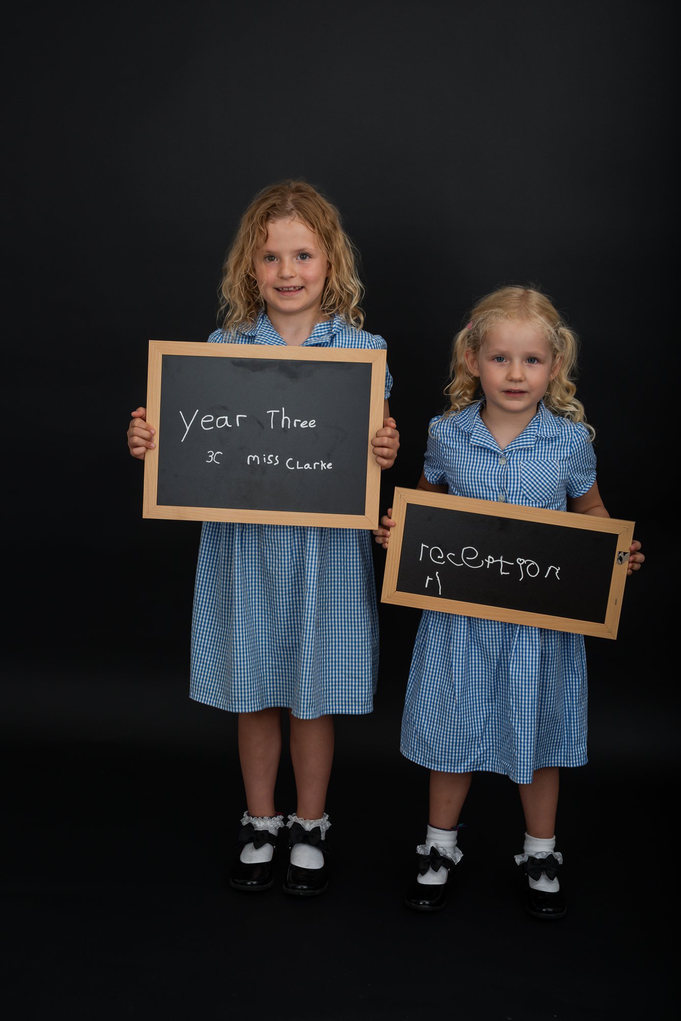 school girls back to school photo shoot with blackboards