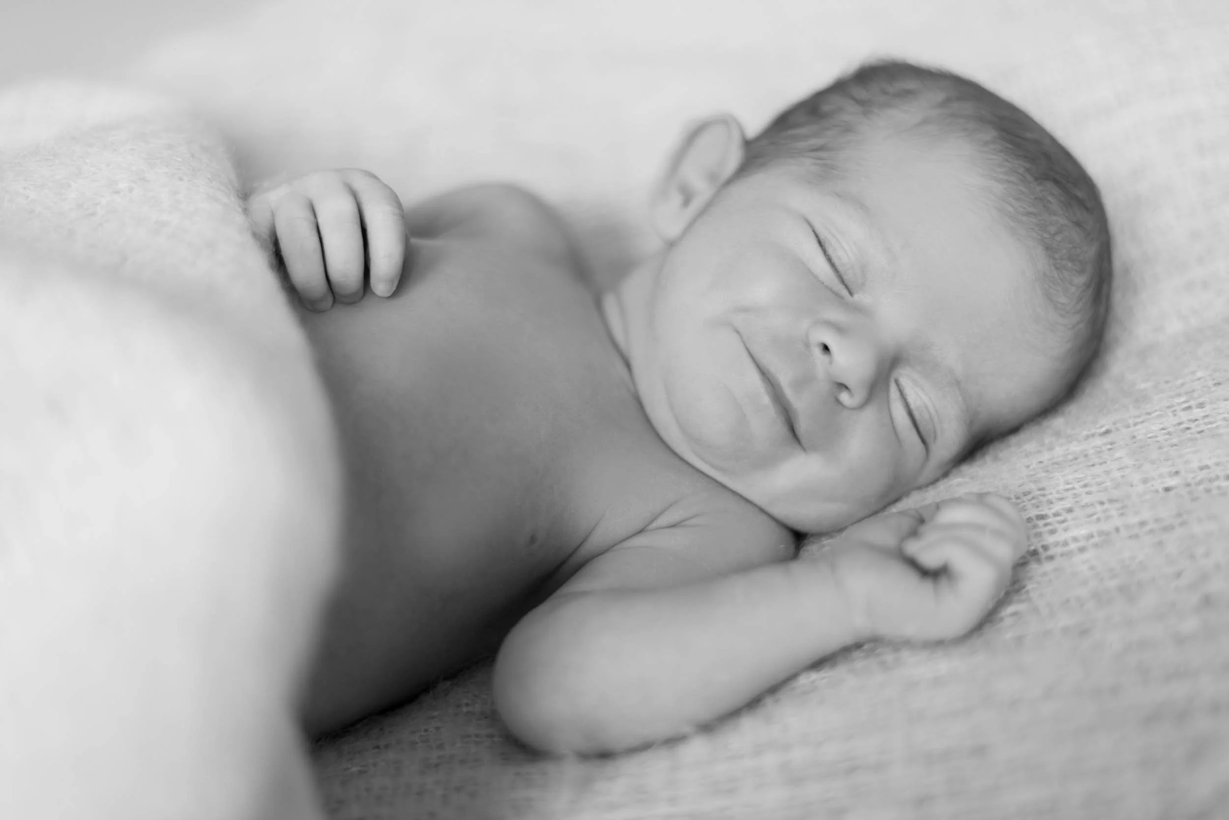 newborn baby smiling