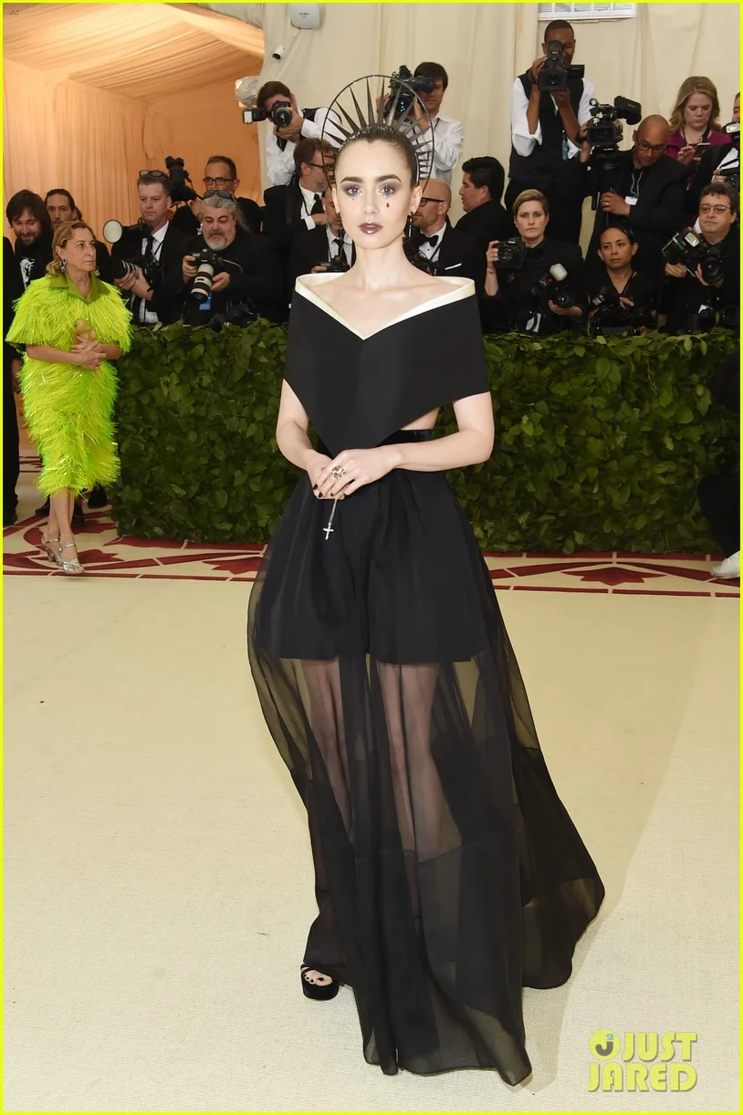 Lily Collins , wearing Givenchy Haute Couture I tend to always like what Lily Collins shows up to events and award shows in. This is no exception. It's very naughty nun, and I'm feeling it.