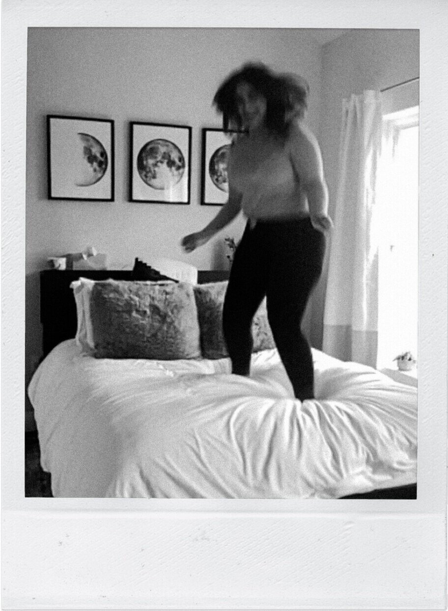 Woman jumping on the bed taken via FaceTime