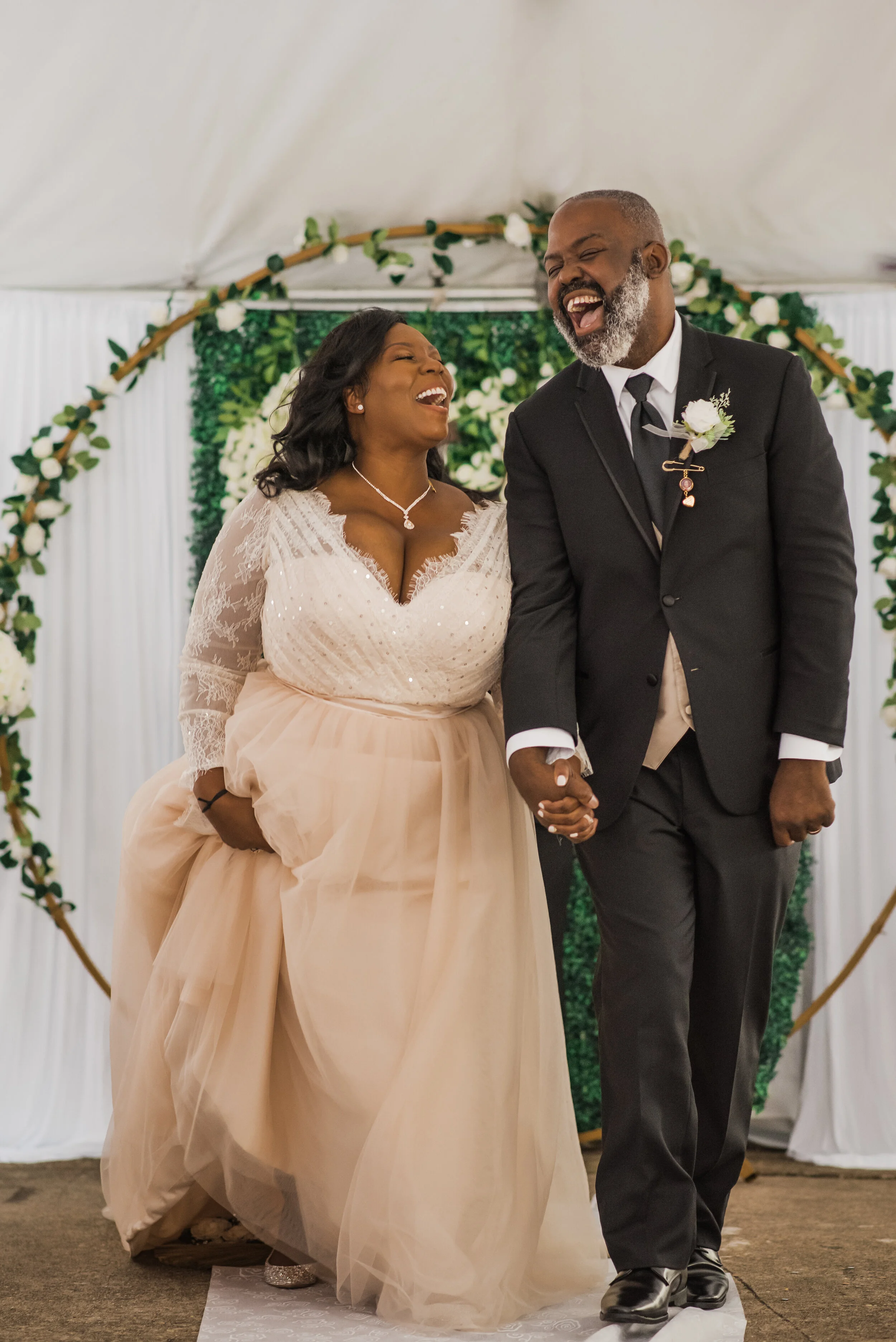 Wedding couple joyously walking down the aisle right after they got married