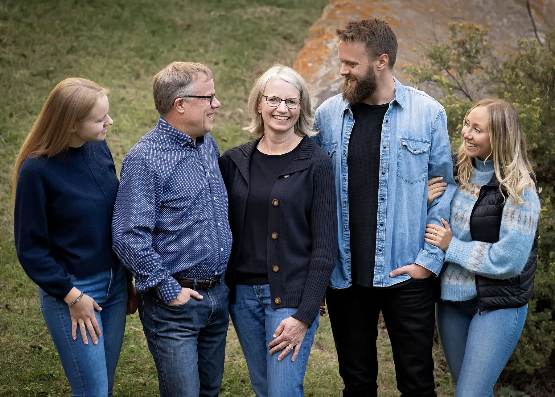 Family wearing coordinated navy and deep tone outfits for fall family photos in Calgary